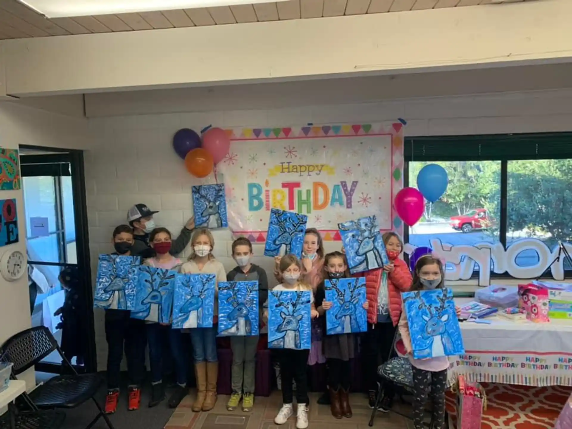 a group of children holding balloons