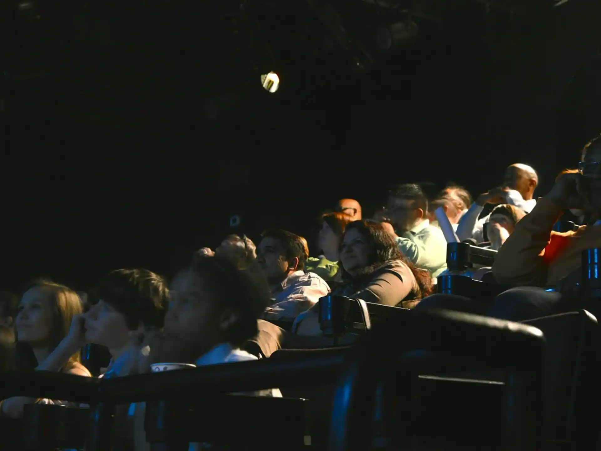a group of people sitting in a dark room