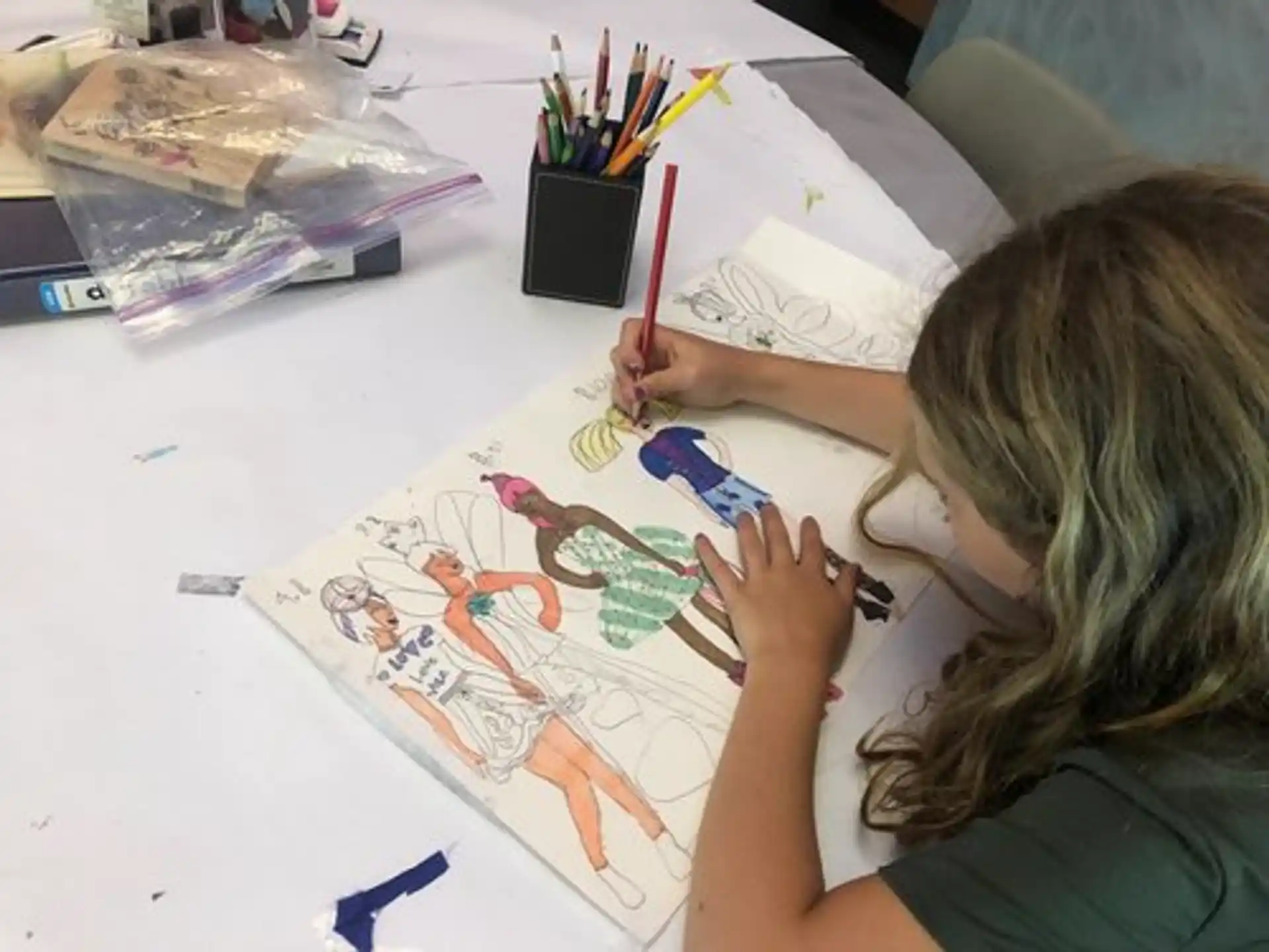 a person drawing on a white table