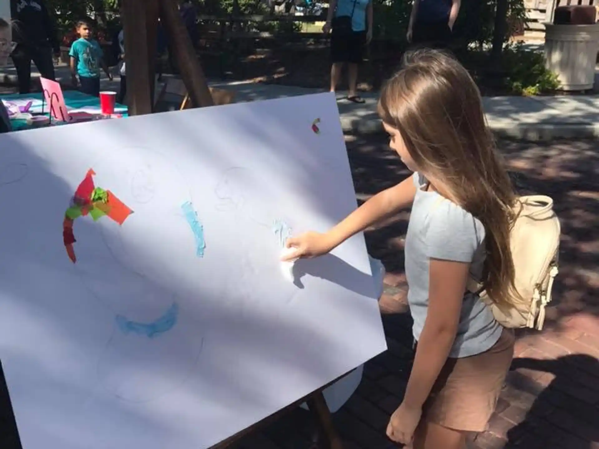 a girl painting a picture
