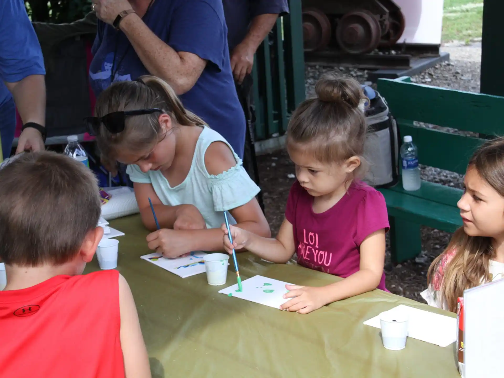 a person and several children sitting at a table