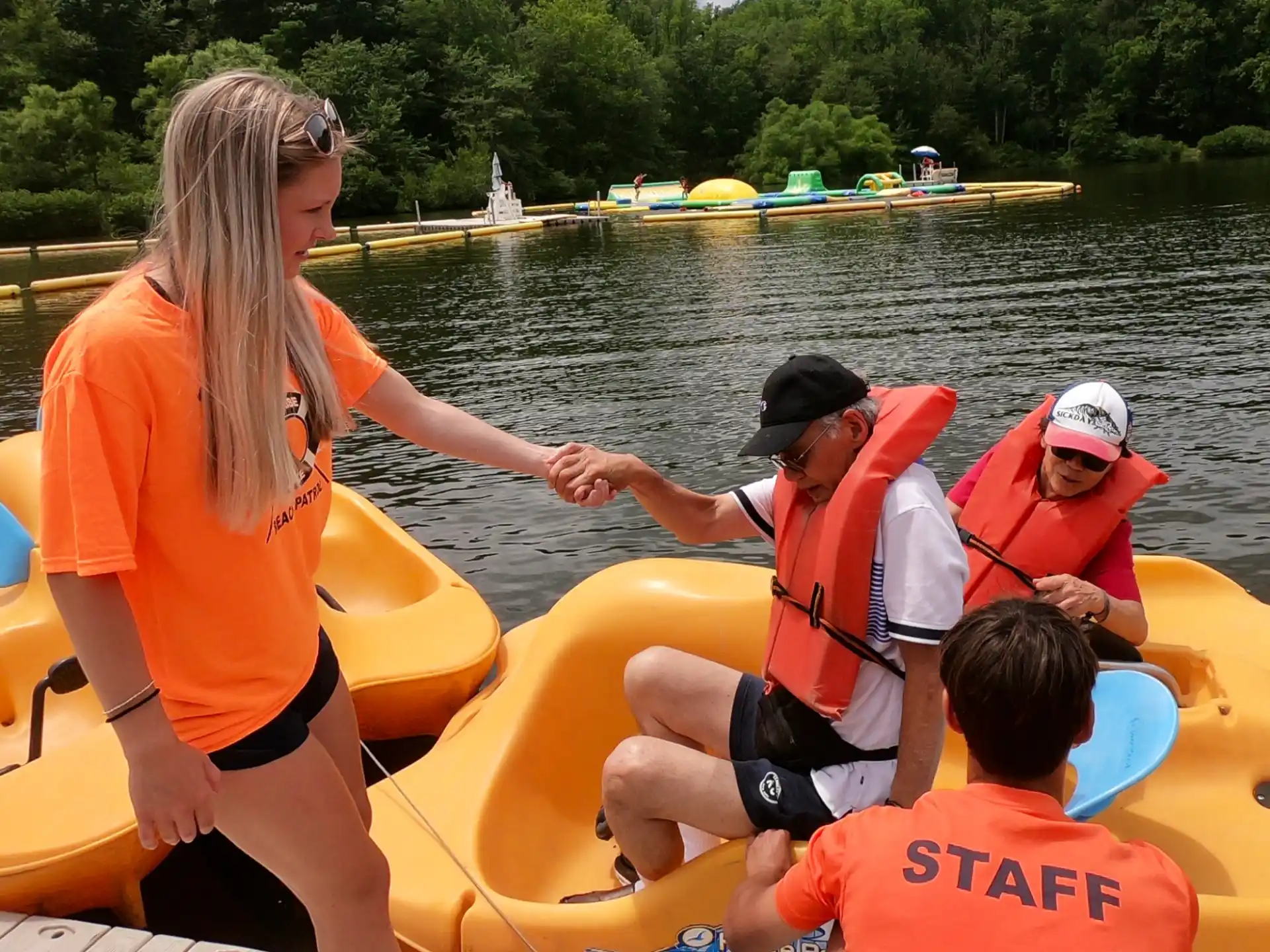 a group of people in life jackets on a boat