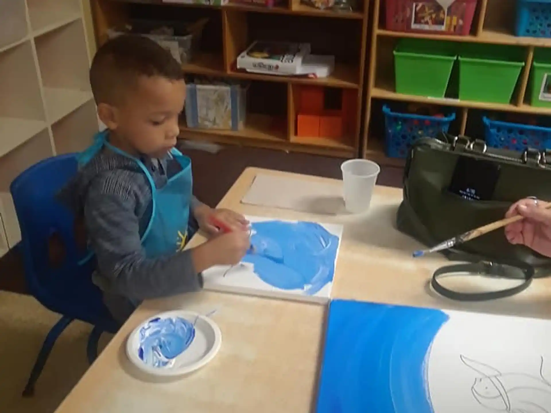 a child painting on a table