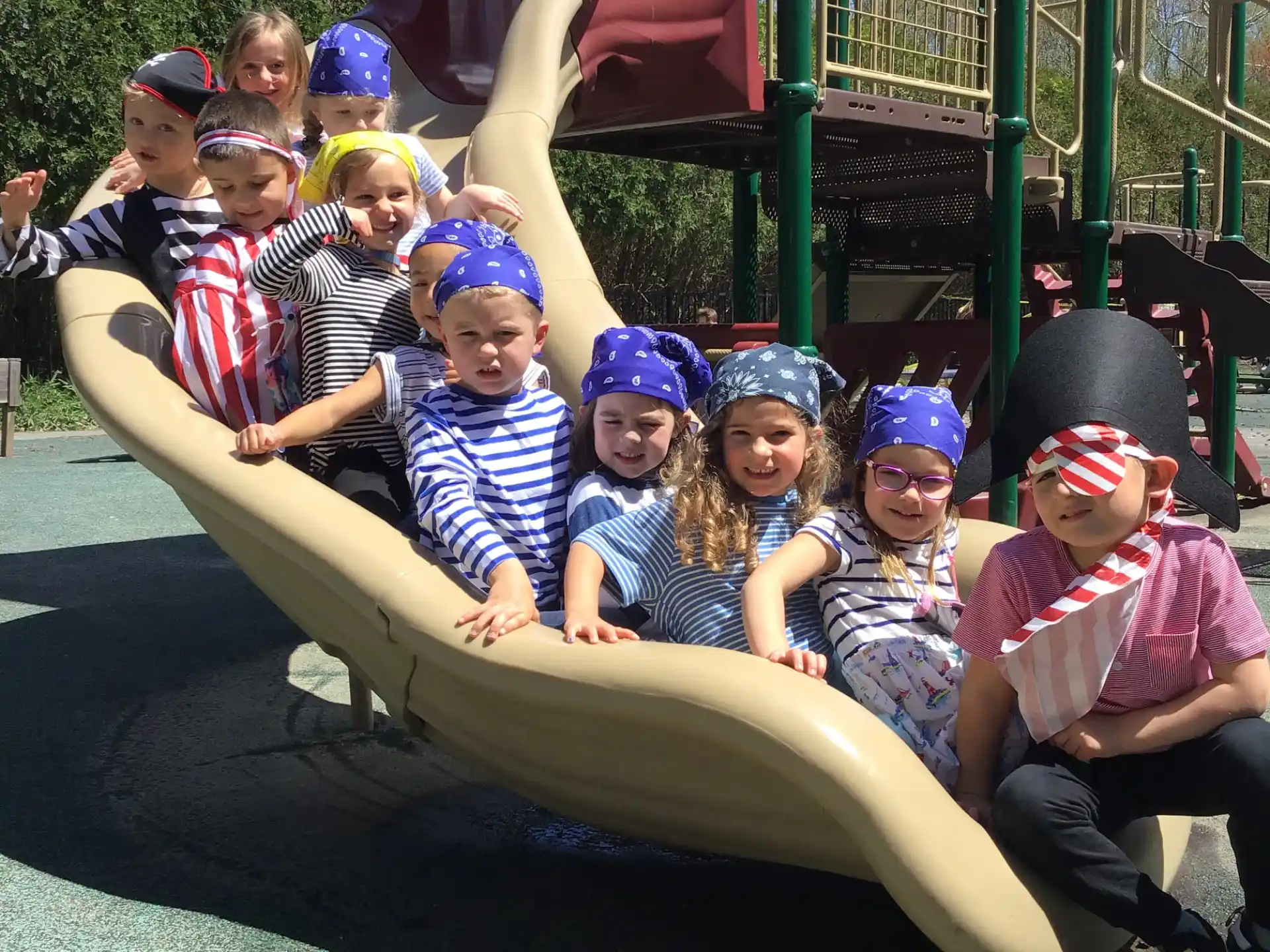 a group of kids sitting on a slide