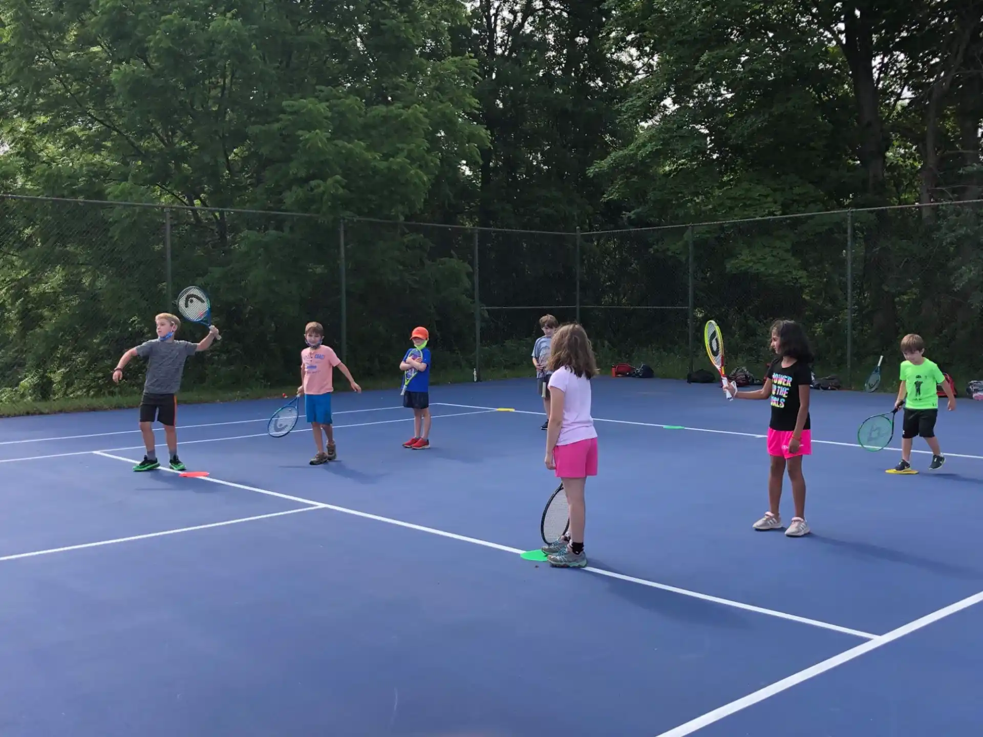 kids playing tennis on a court