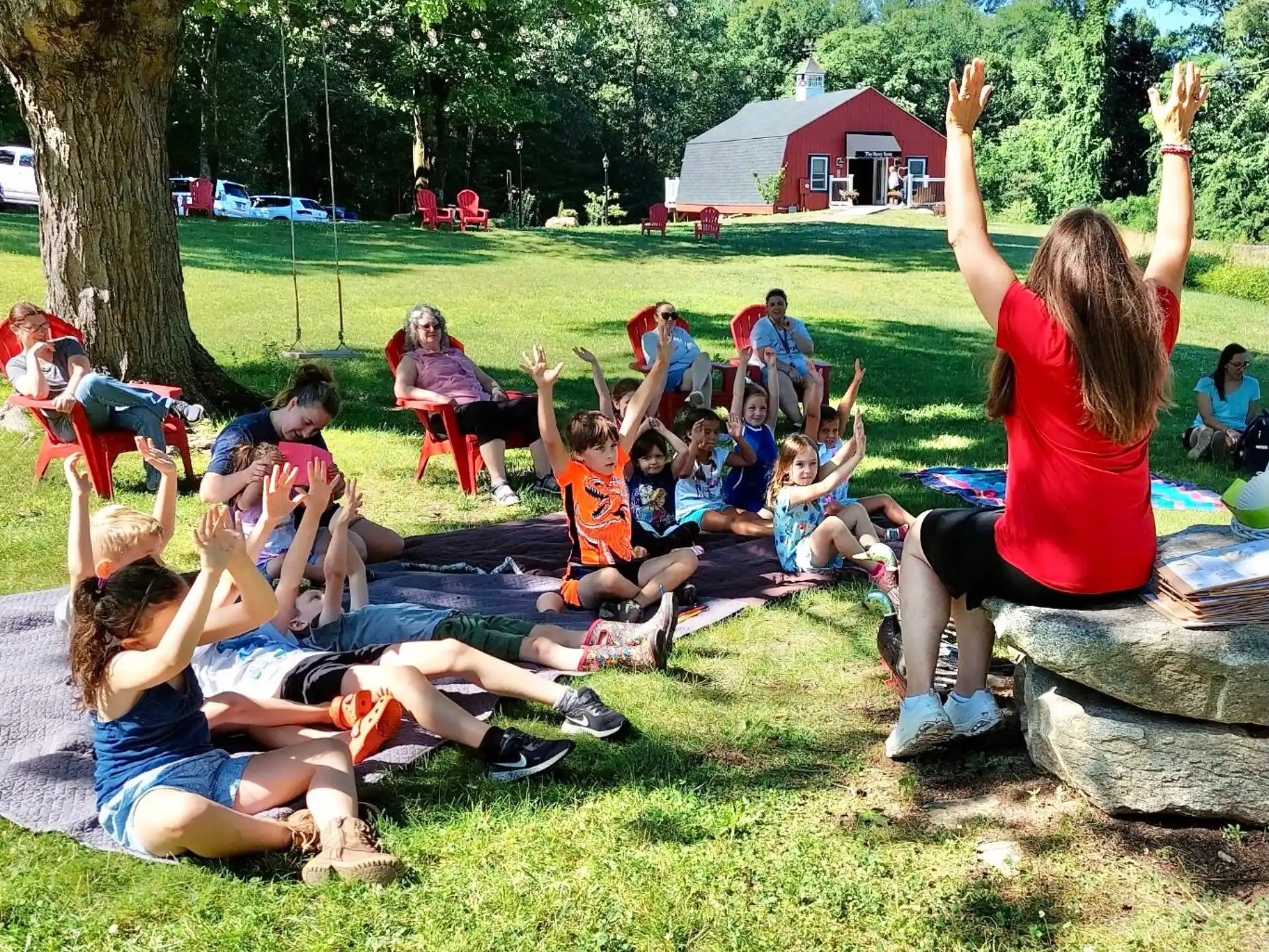 a group of people sitting on the grass