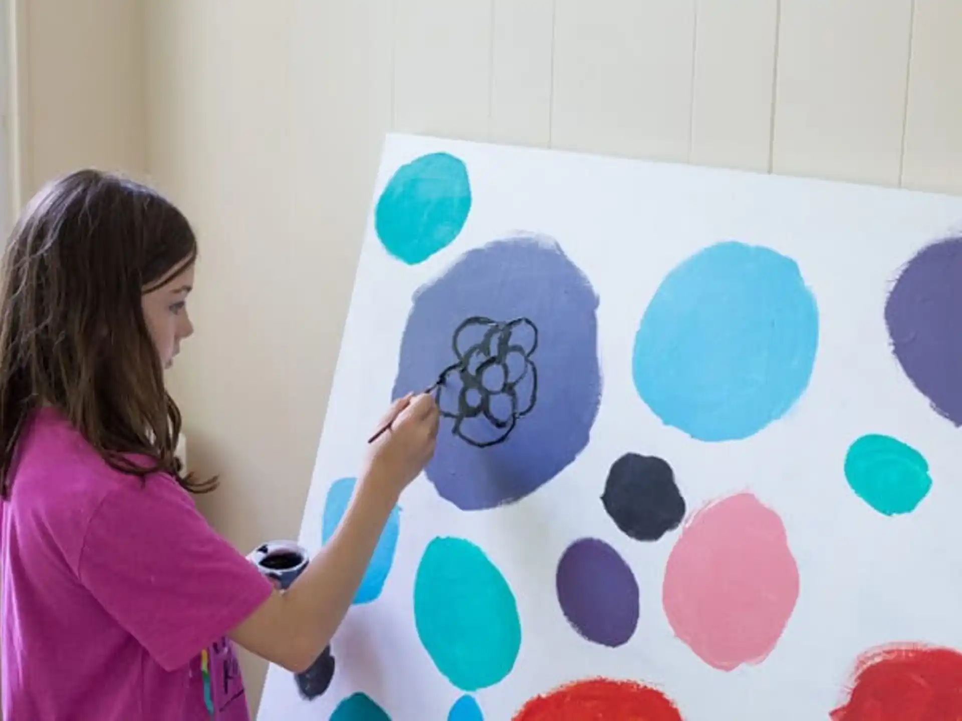 a woman painting a picture
