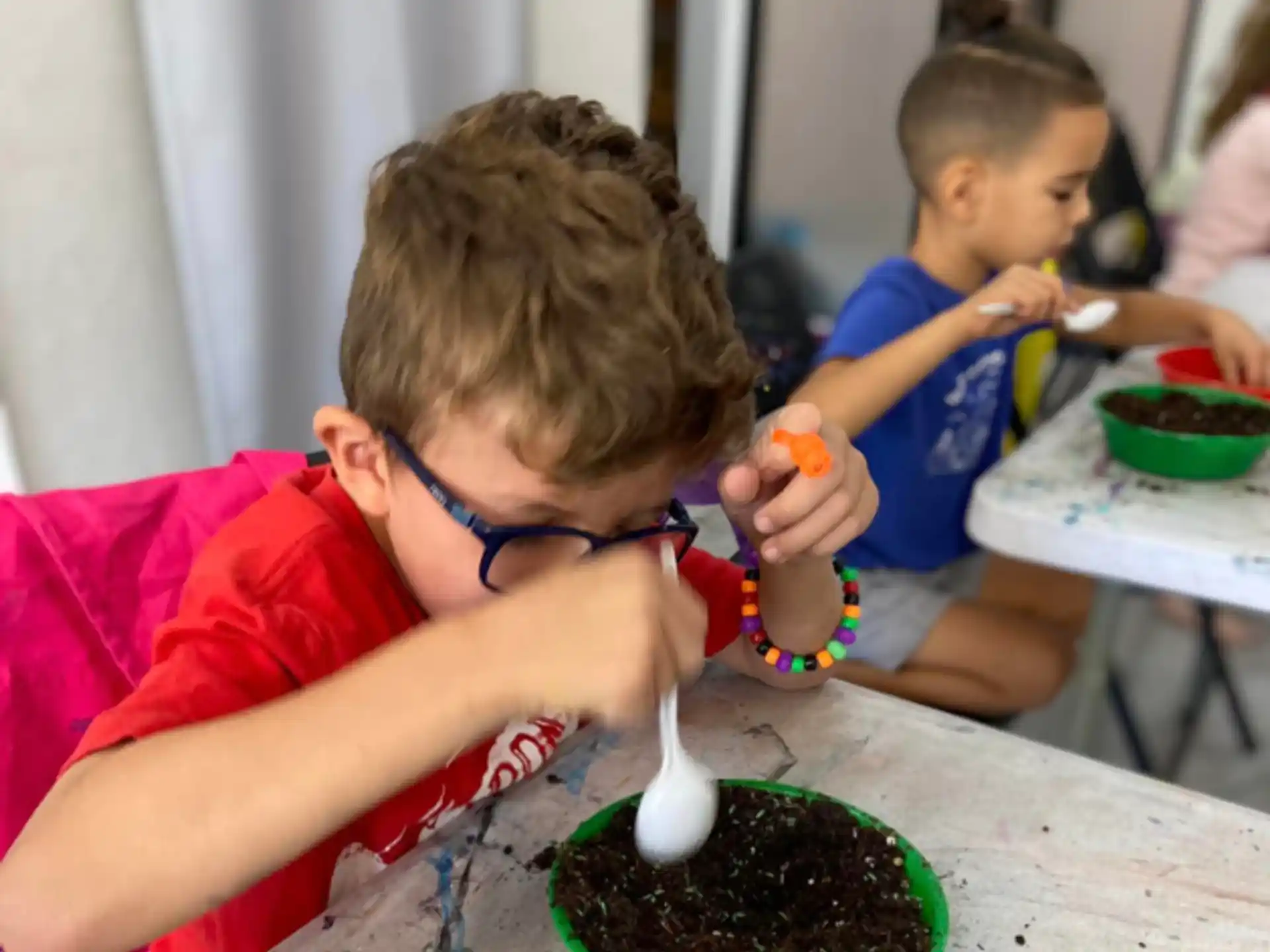 a couple of boys eating from bowls