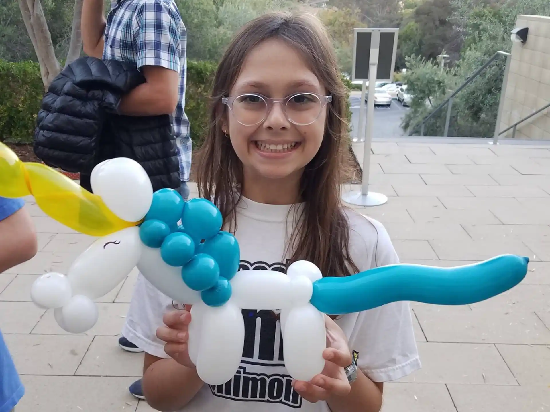 a woman holding a bunch of balloons