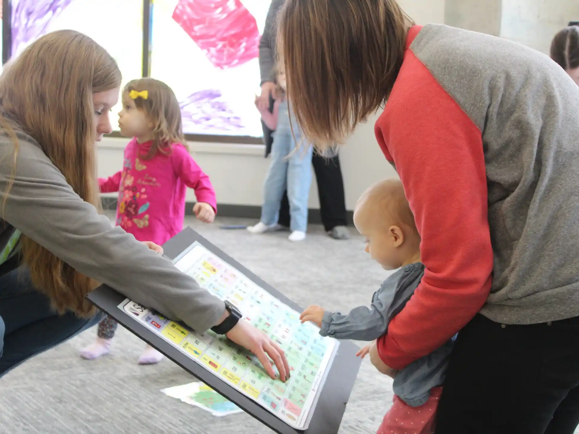 a person showing a child something on a computer