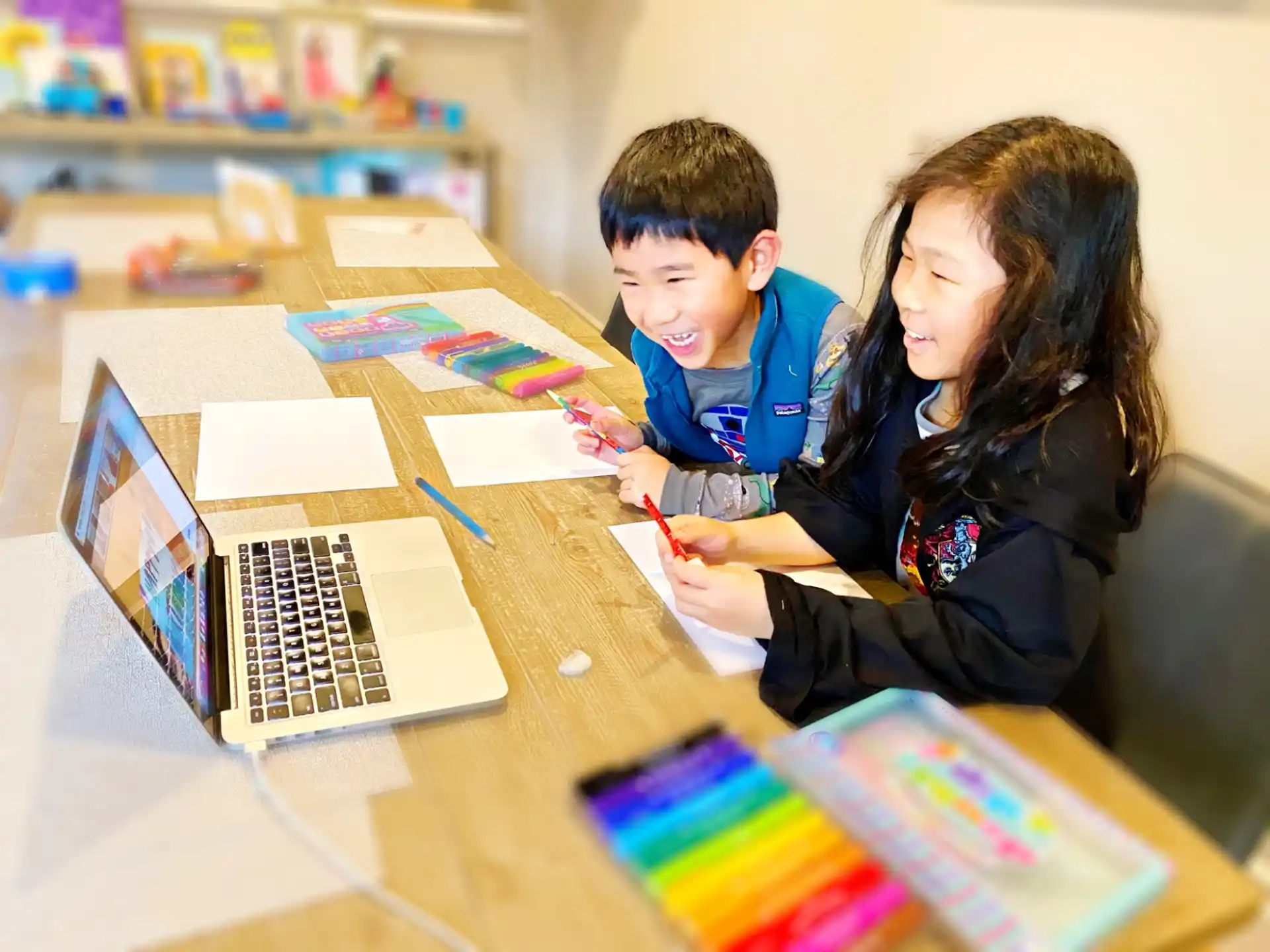 a person and a boy working on a laptop