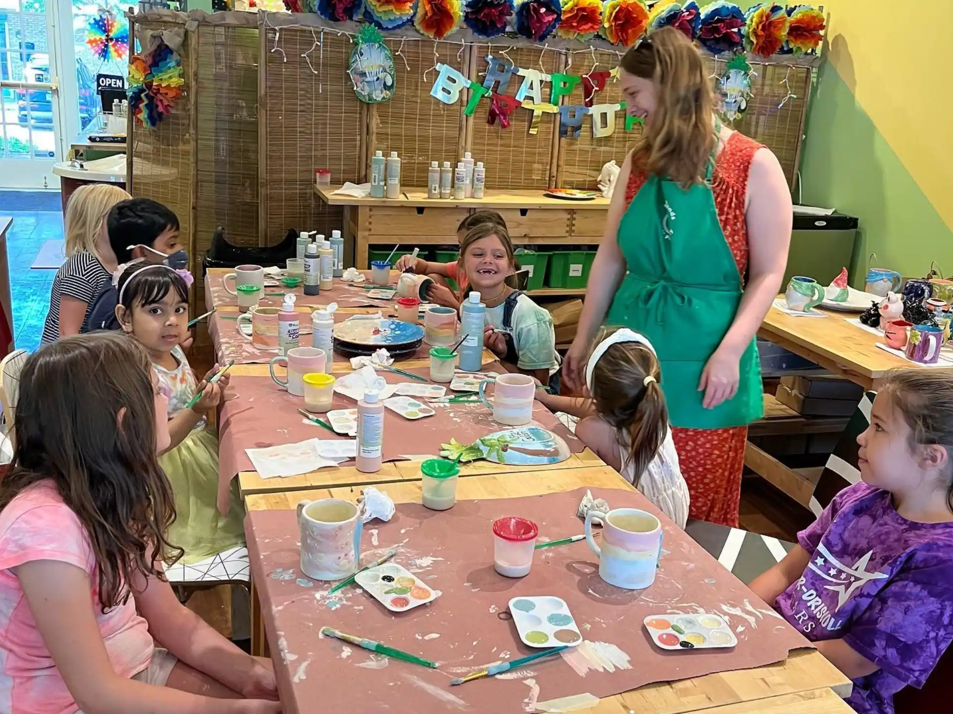 a group of children sitting at a table