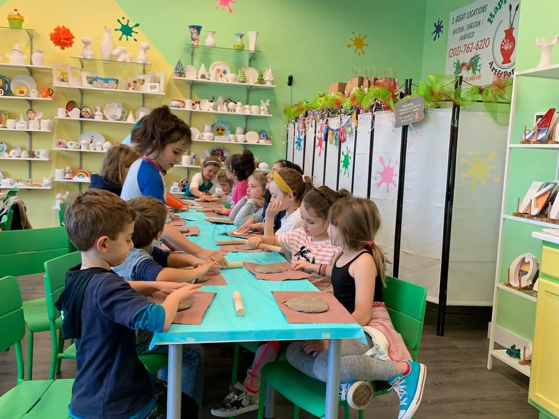 a group of children sitting at a table in a classroom