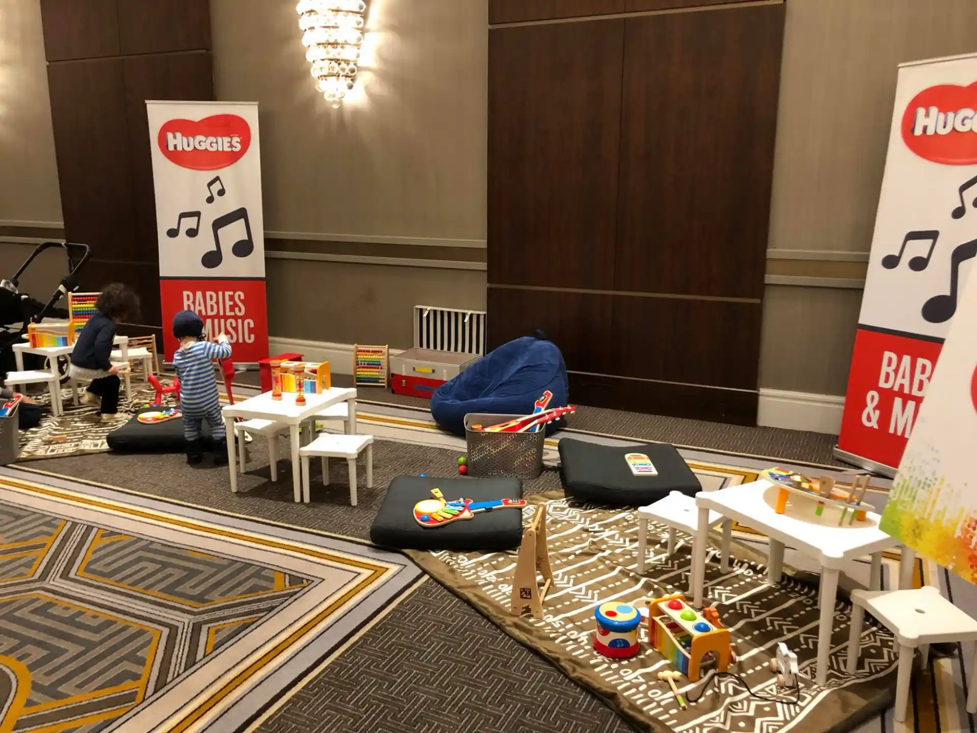 a group of kids playing on toy trains