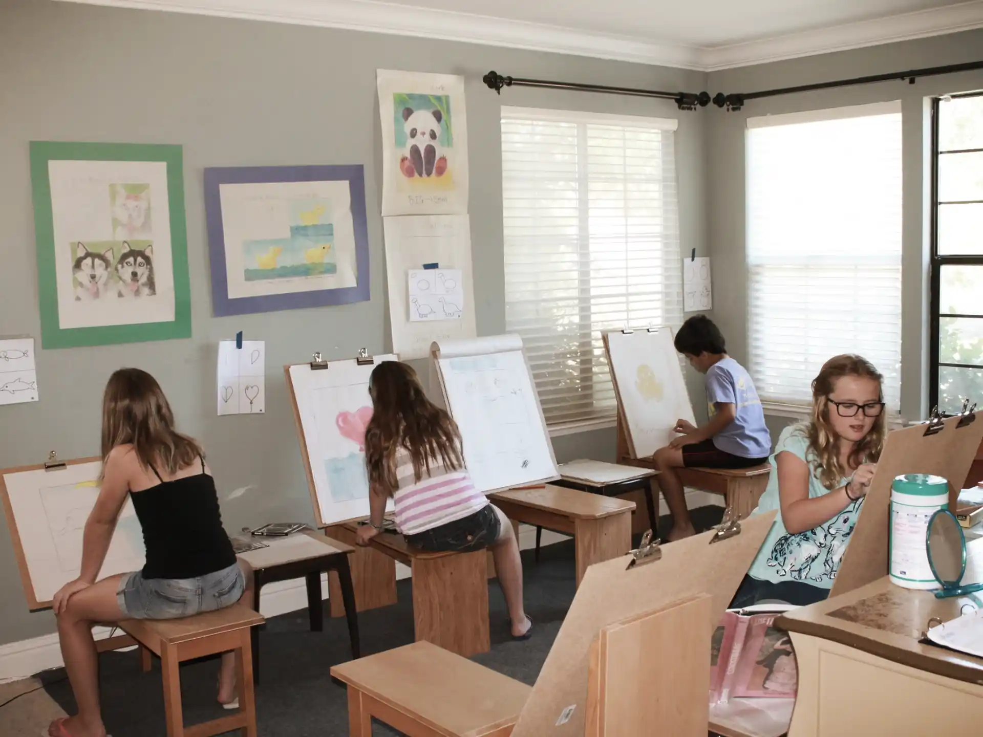 a group of people sitting at desks in a classroom