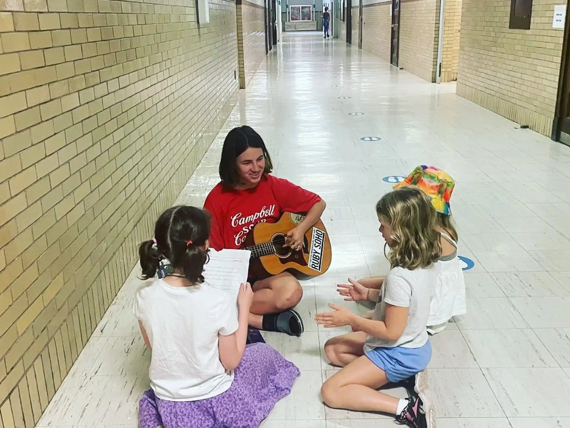 a person and two children sitting on the floor