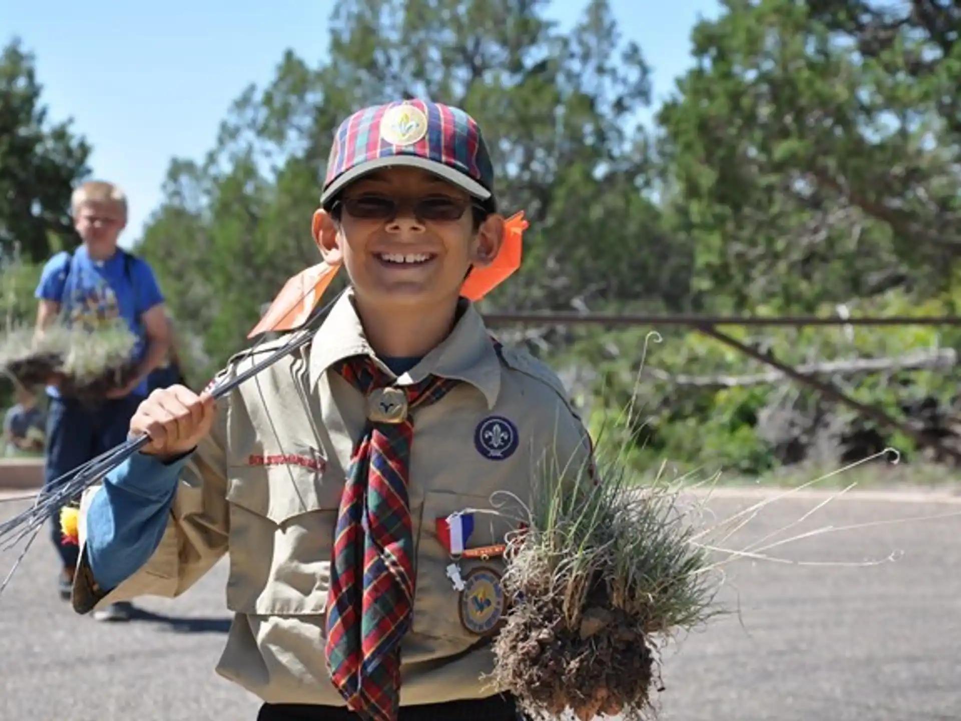 a boy in a uniform holding a bow and arrow