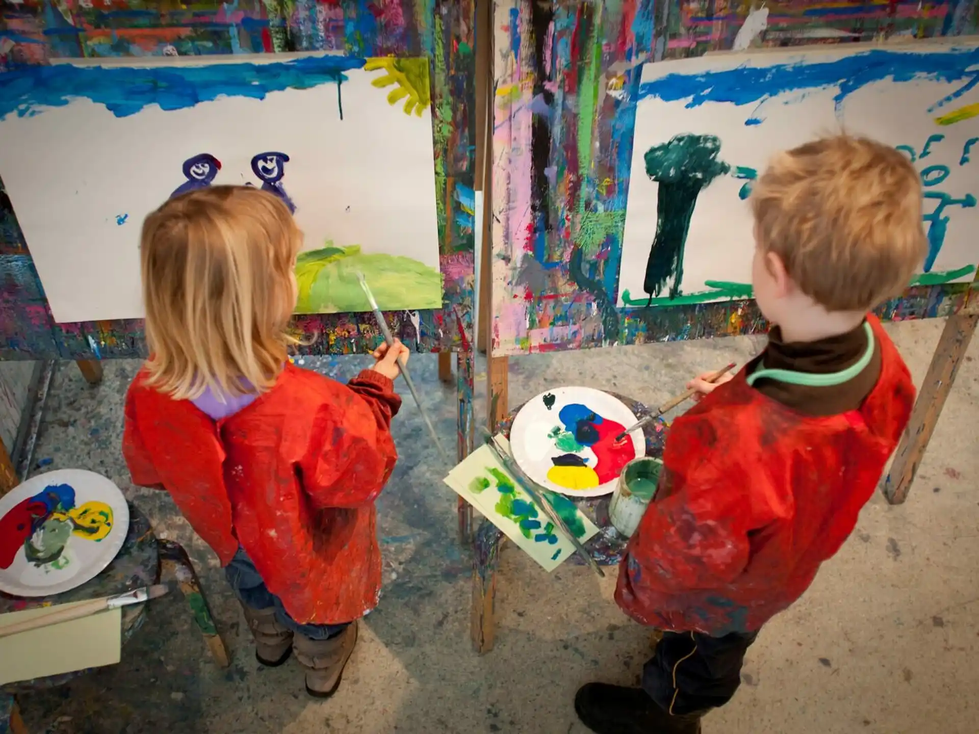 children painting on a wall