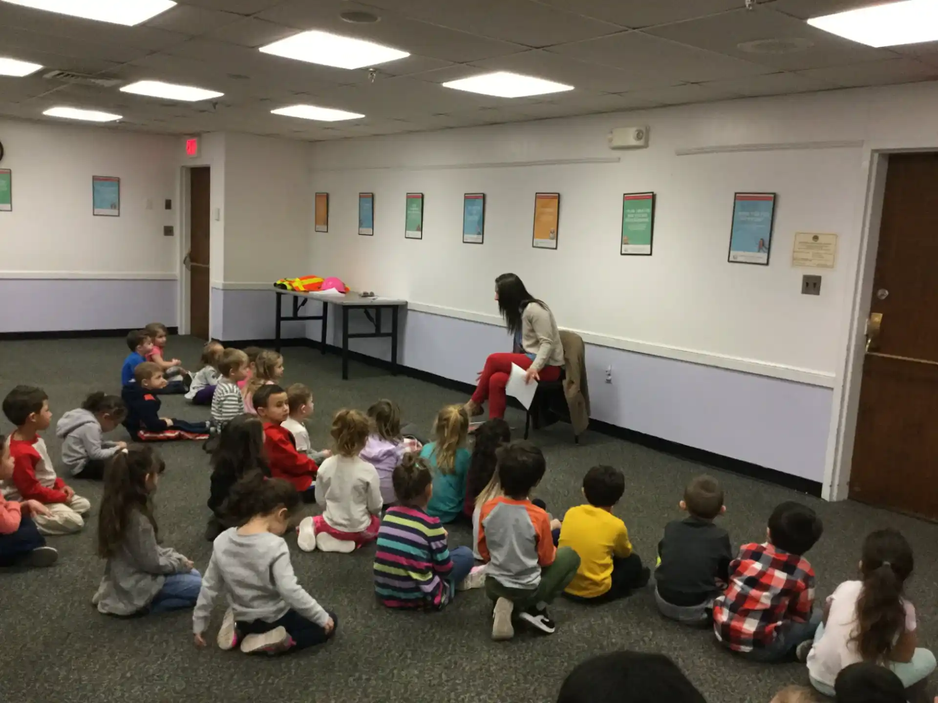 a group of children sitting in a circle in a room