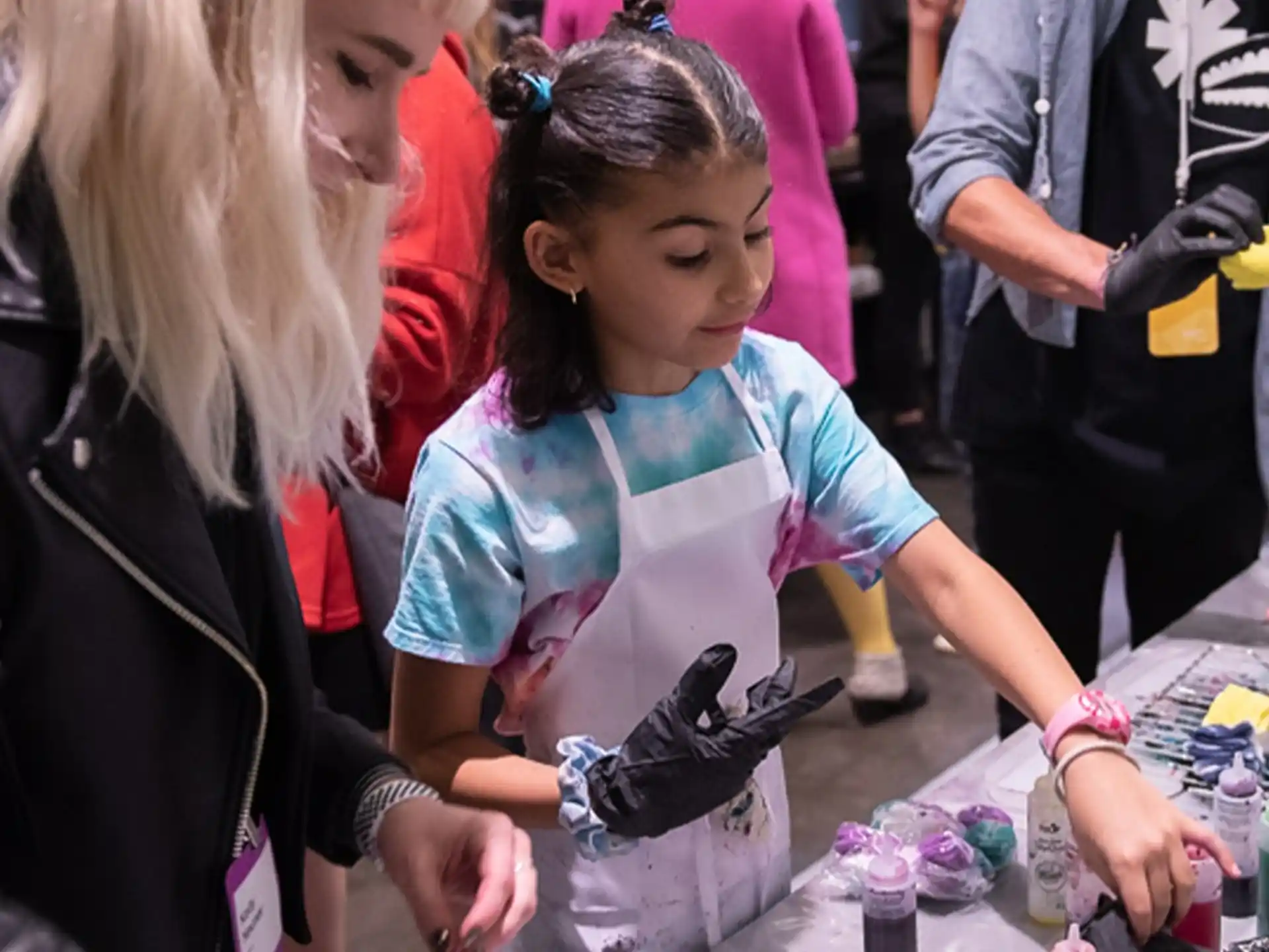 a person helping a girl with a toy