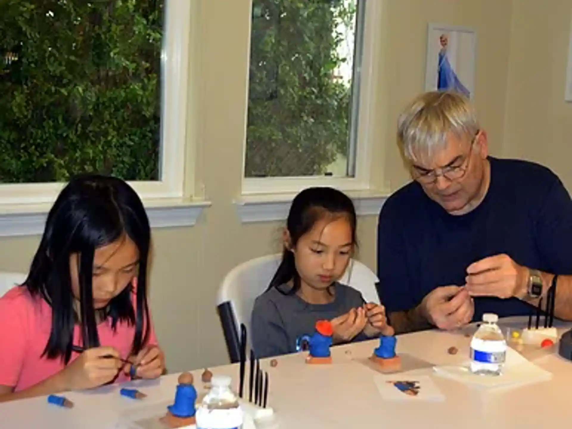 a person and a girl sitting at a table with a child