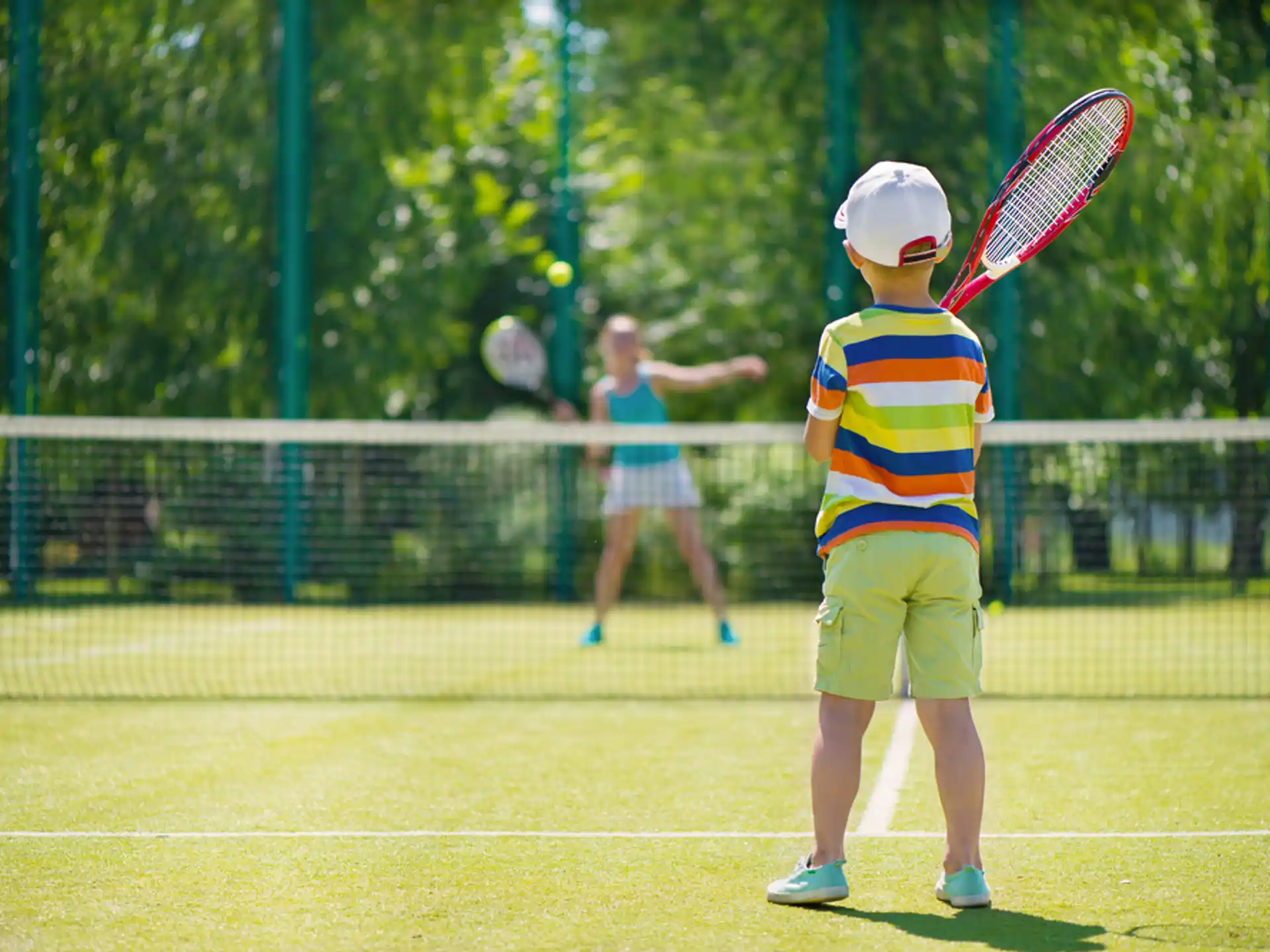 a kid playing tennis