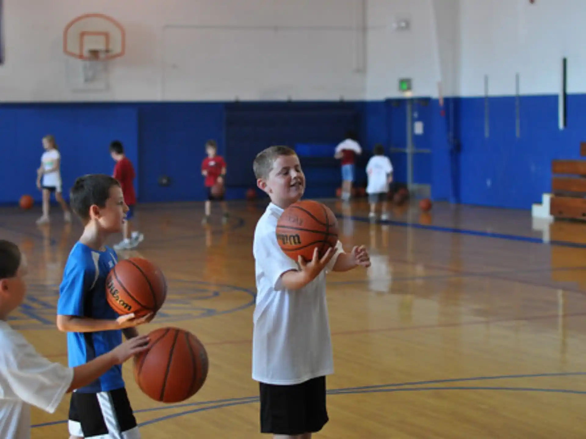 a group of kids playing basketball