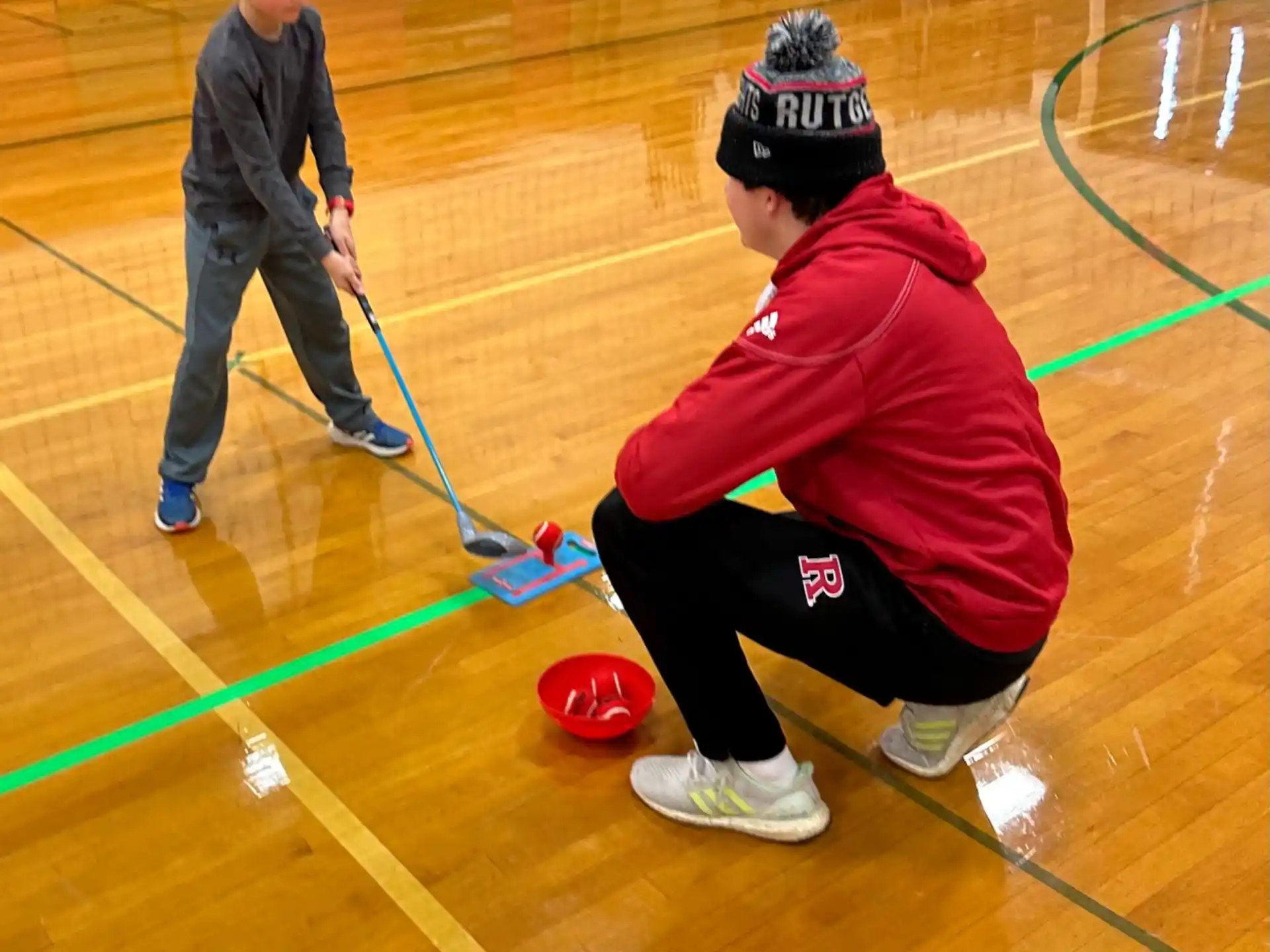 a boy playing hockey with a stick