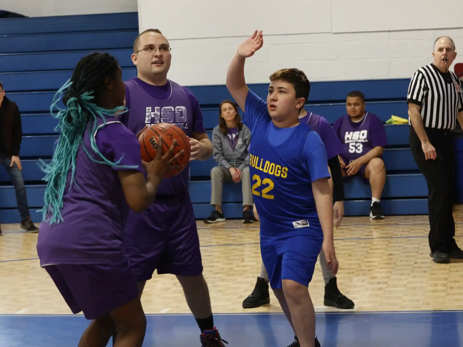 a group of people playing basketball