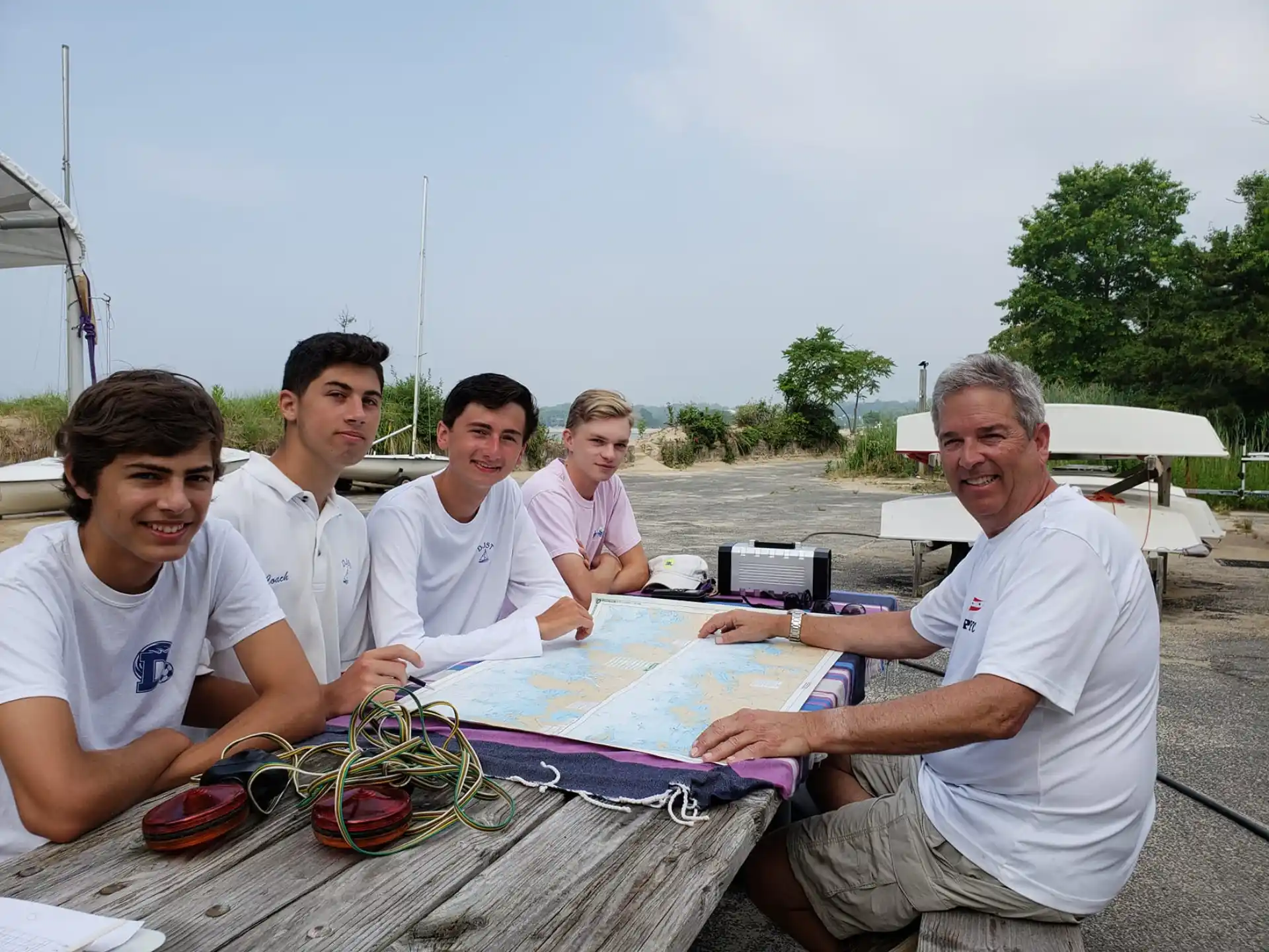 a group of people sitting at a table with a board game