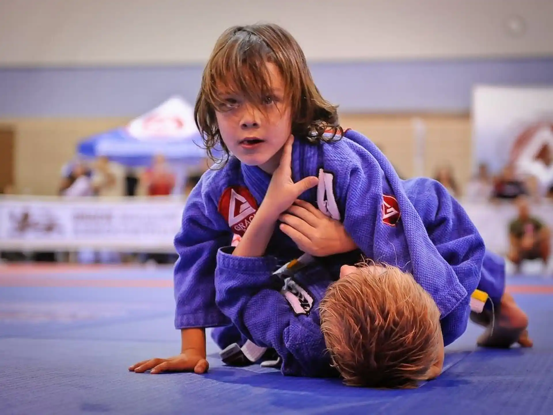 a young girl kneeling on the floor
