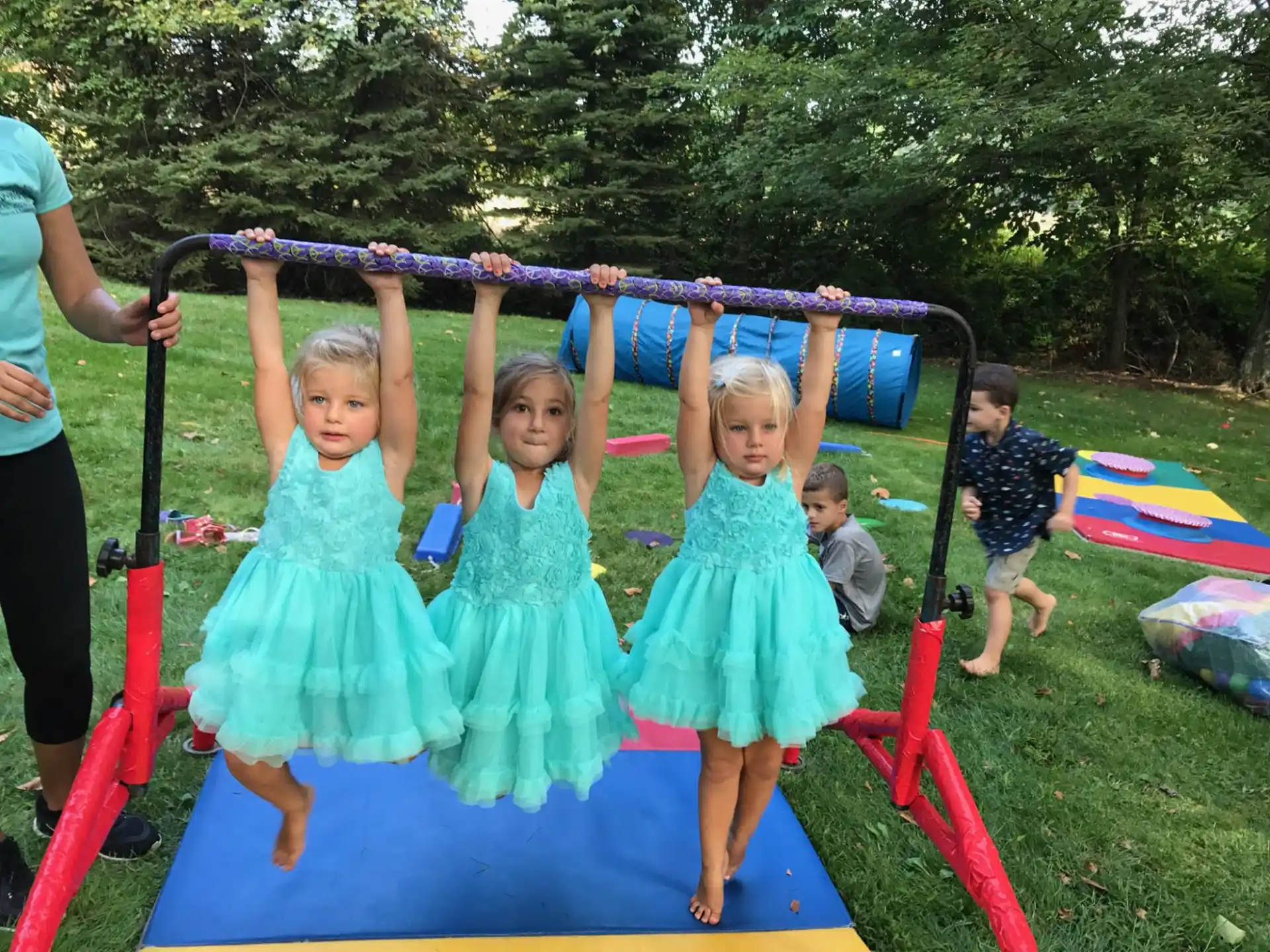 a group of children in dresses on a playground