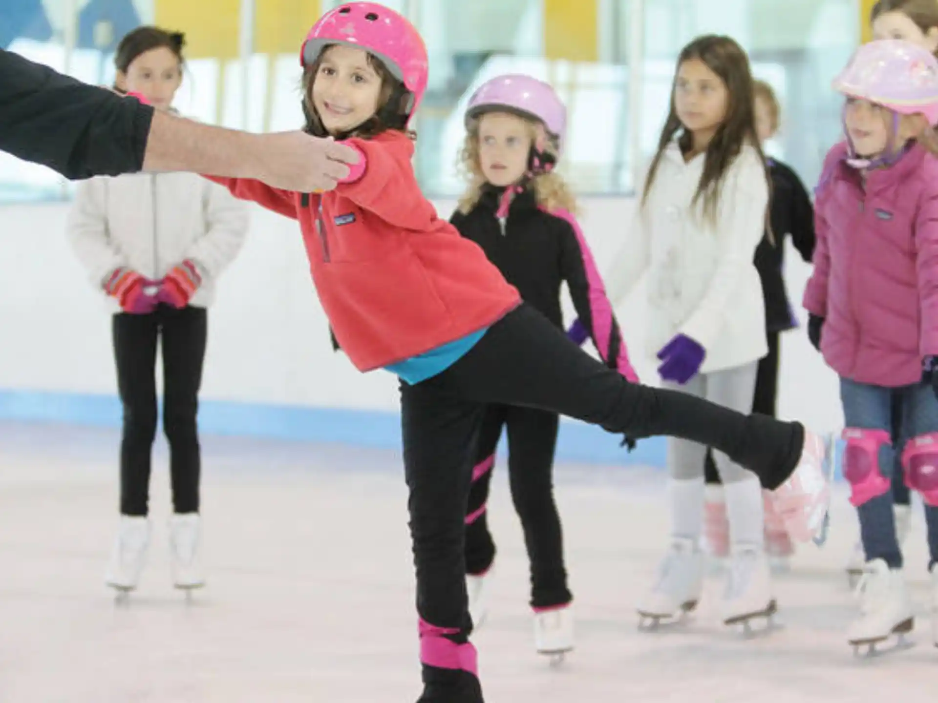 a group of people wearing ice skates and helmets