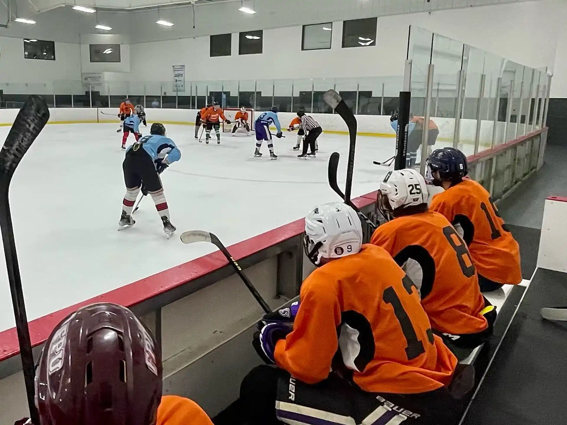 a group of people playing hockey