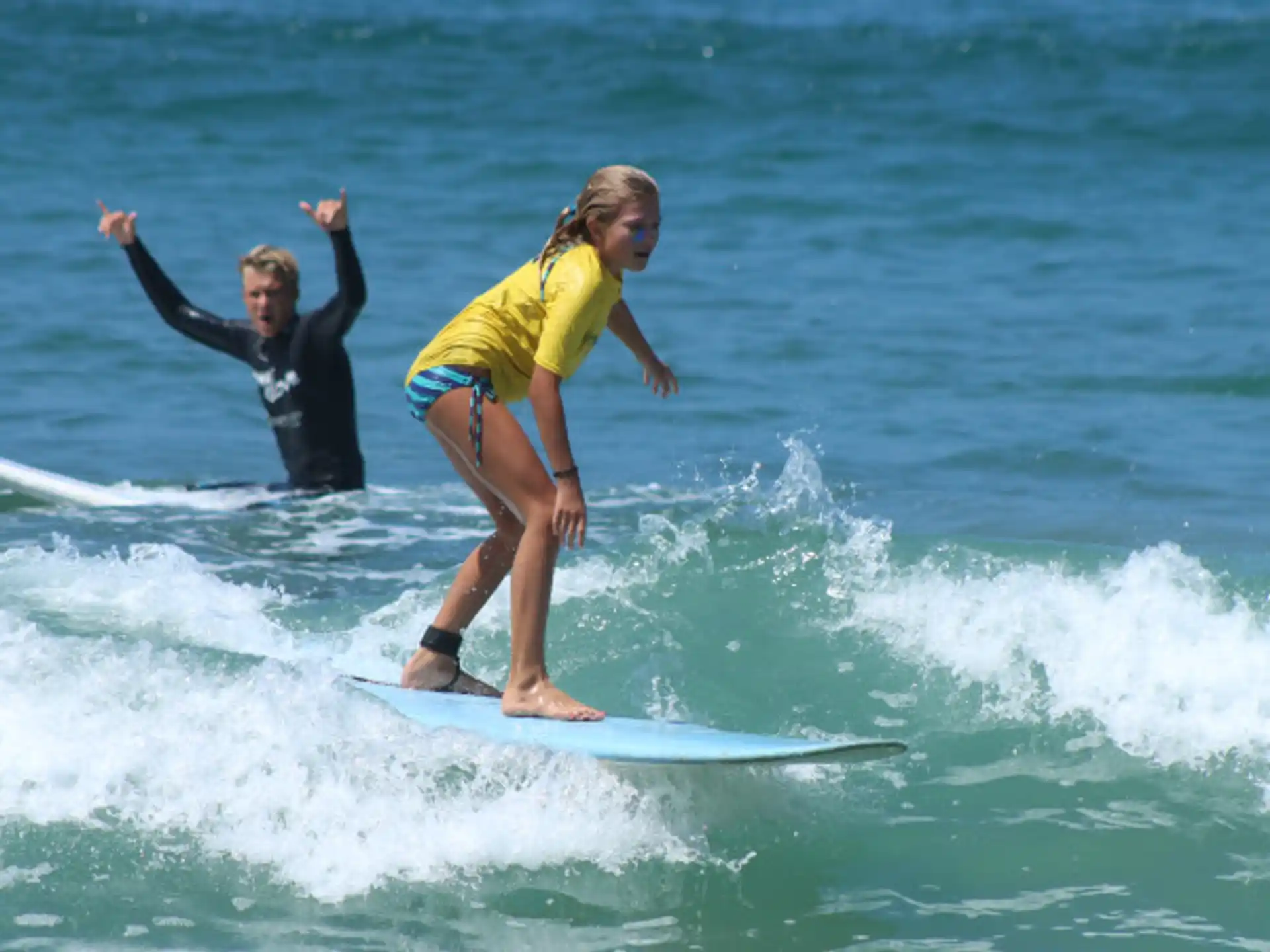 a man and a woman surfing