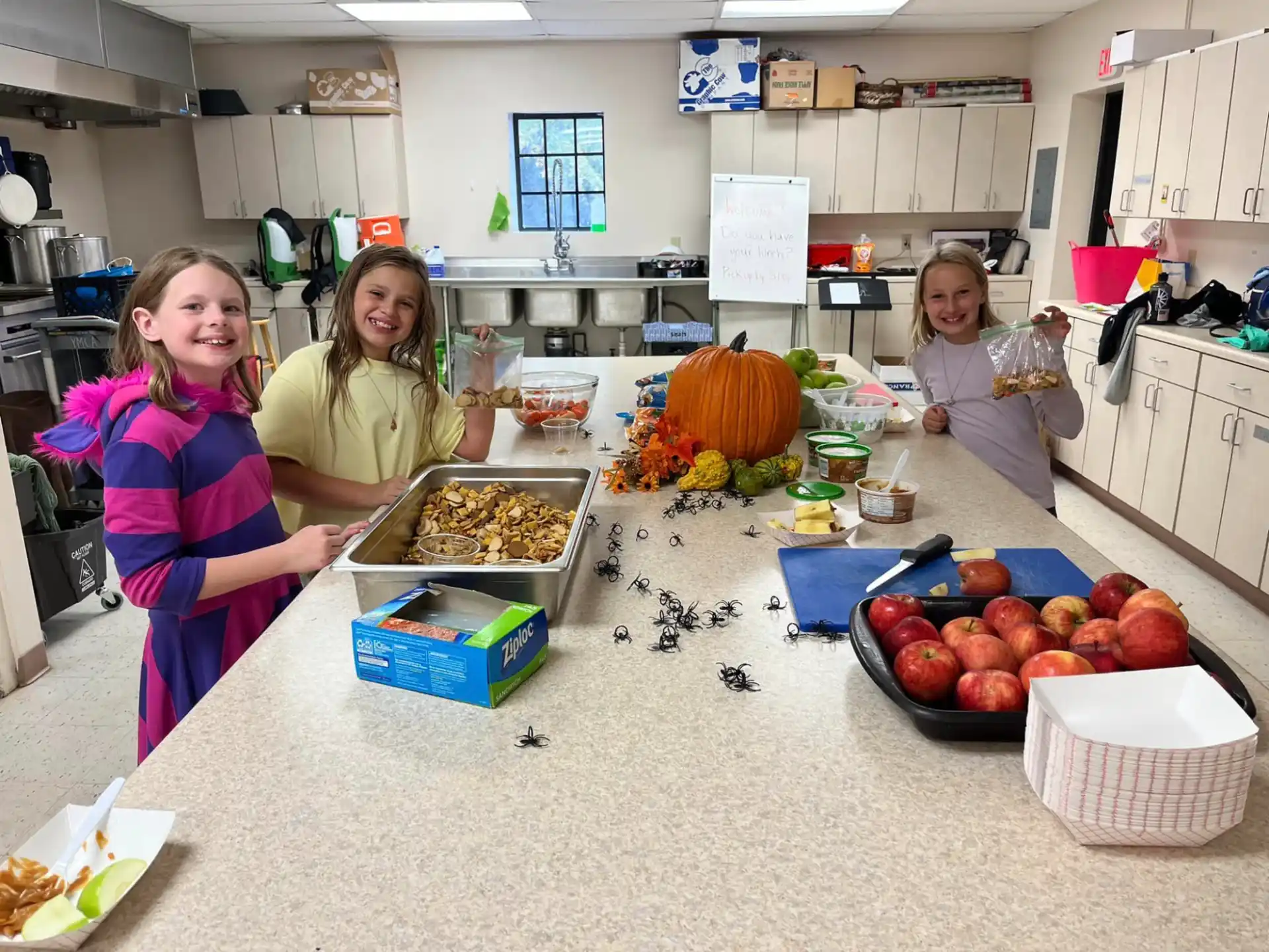 a group of girls in a kitchen