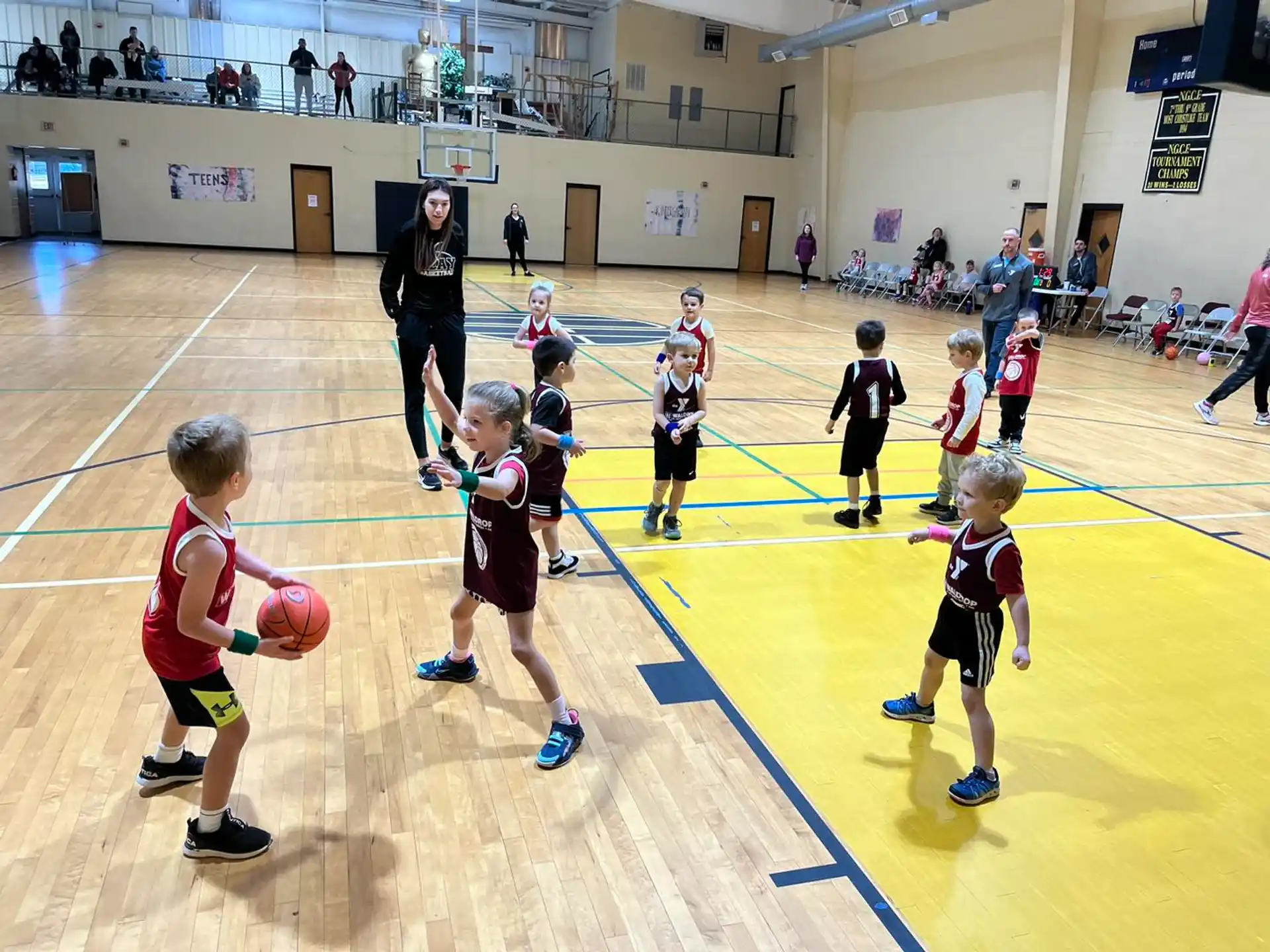 a group of kids playing basketball