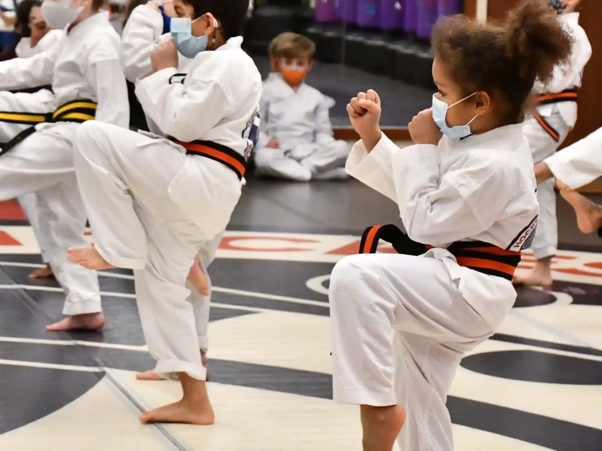 a group of children in karate uniforms