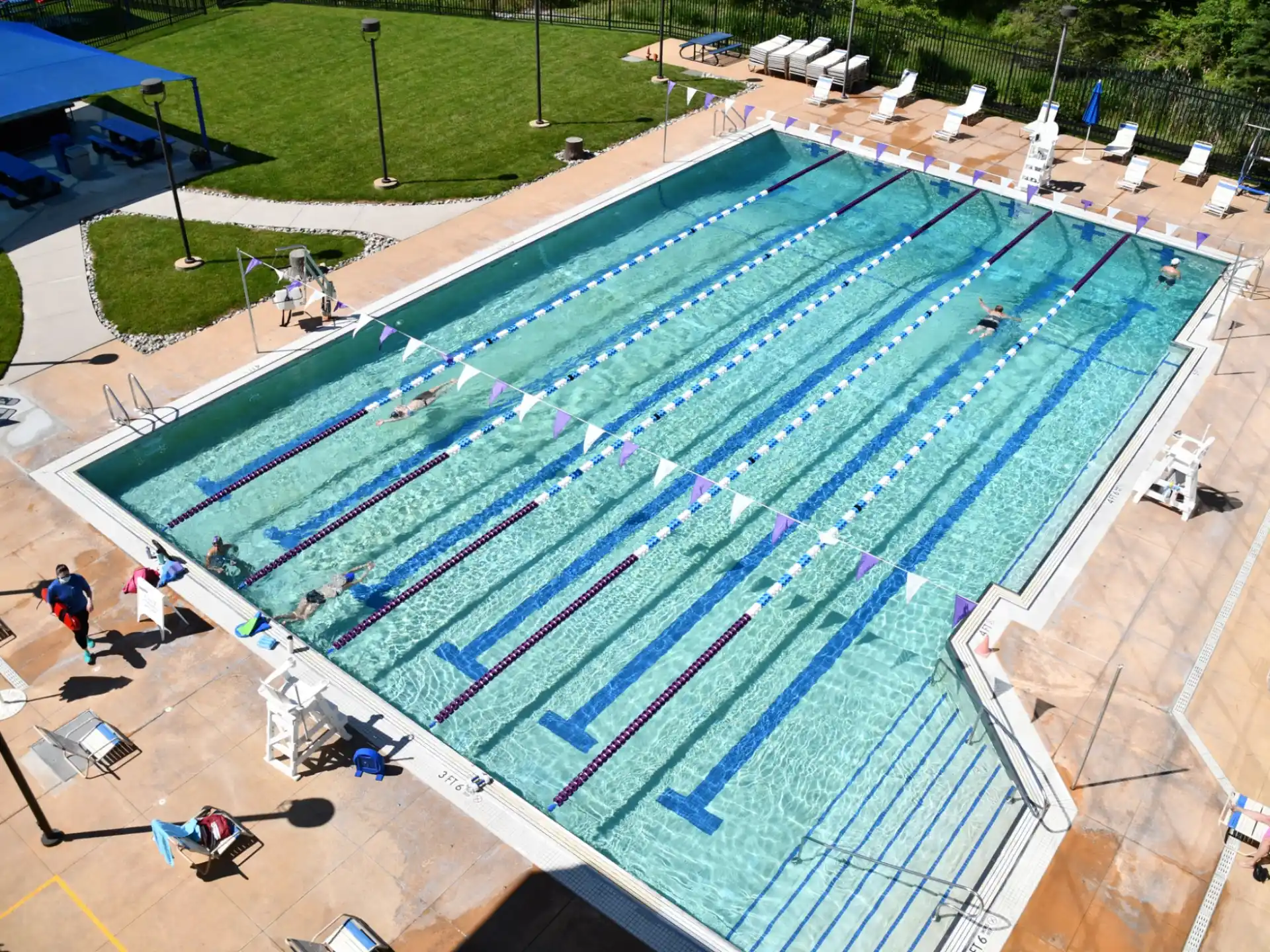 a swimming pool with people around it