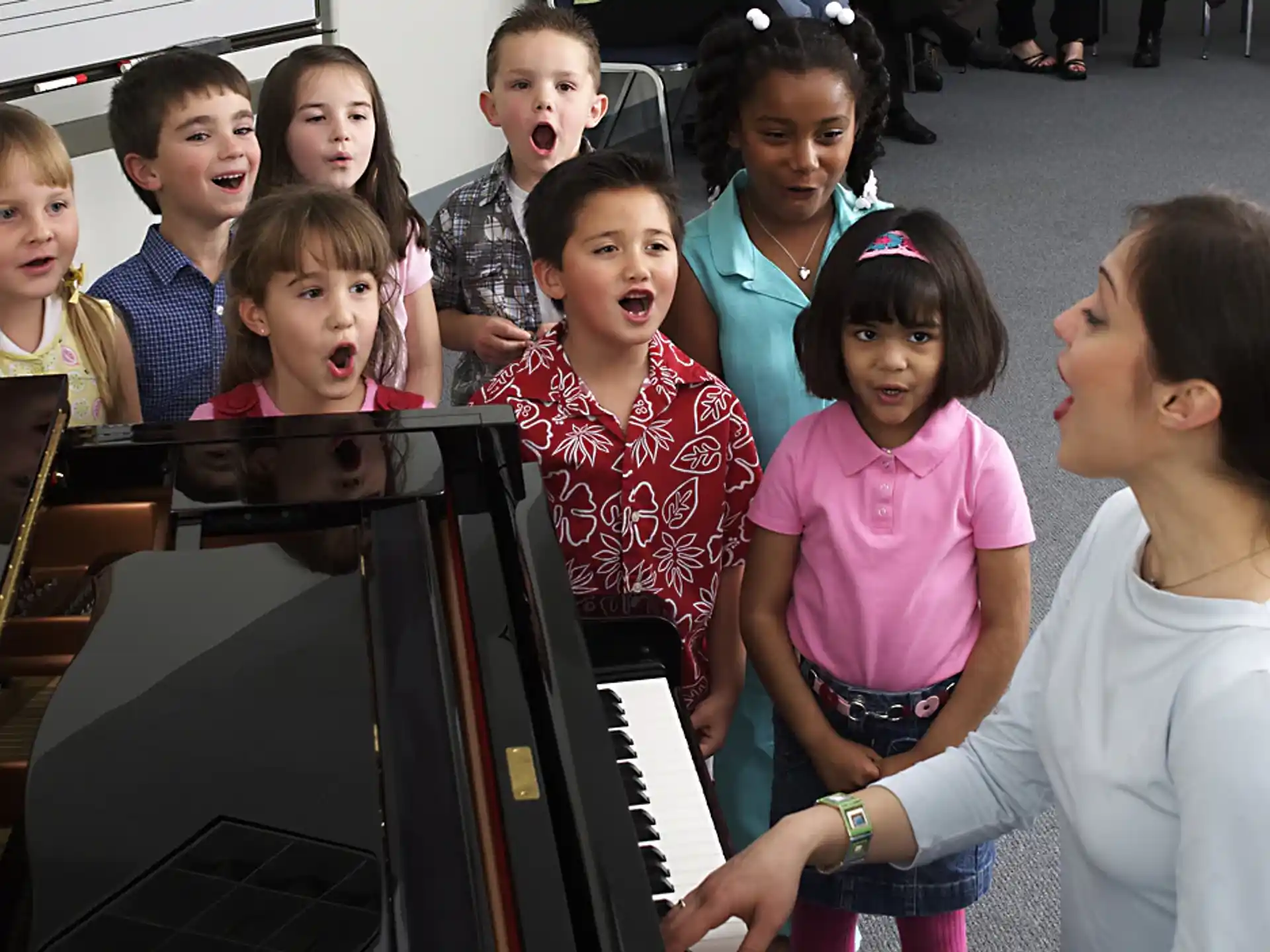a group of children playing piano