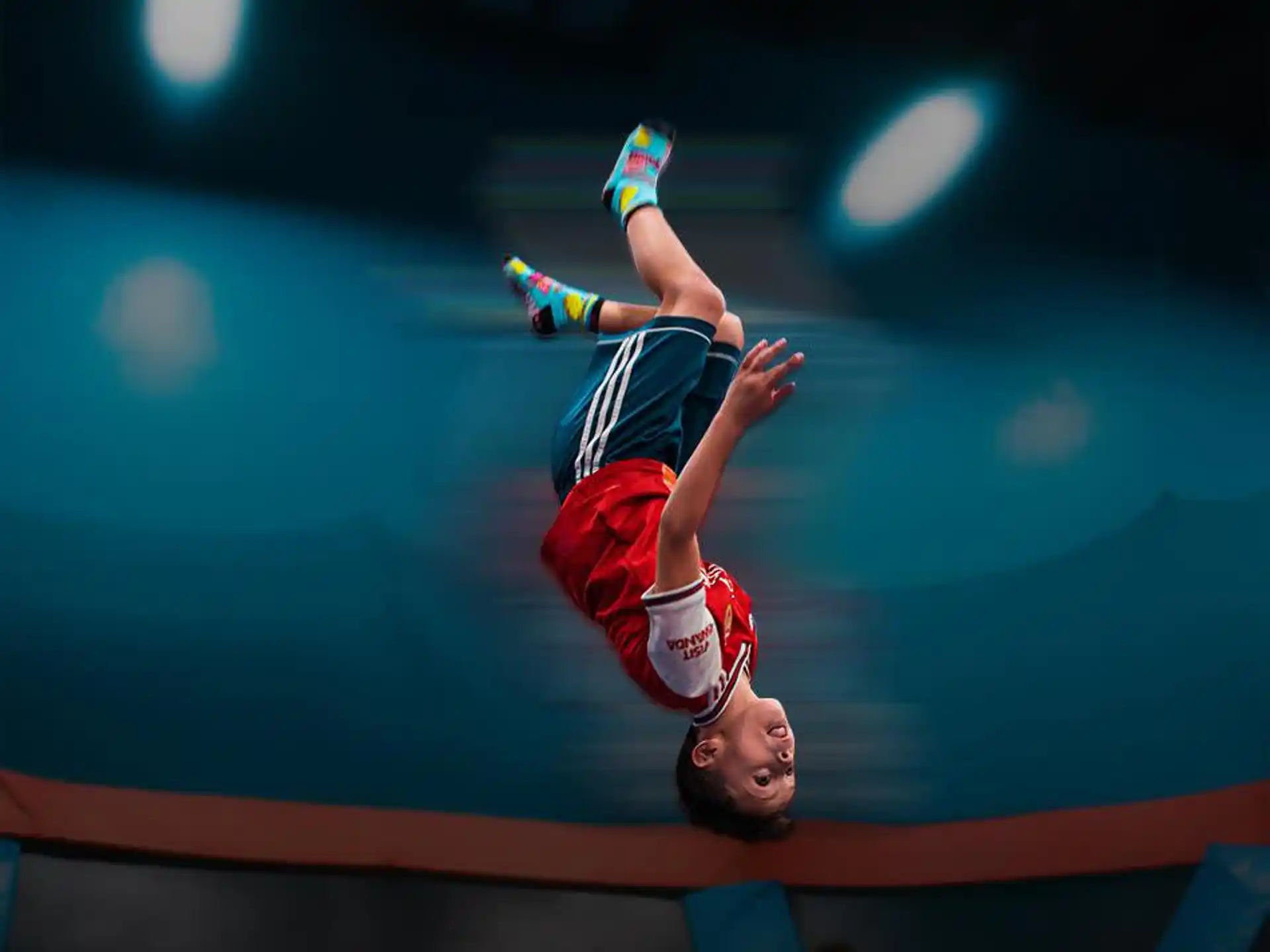 a person in a red and white uniform jumping in the air