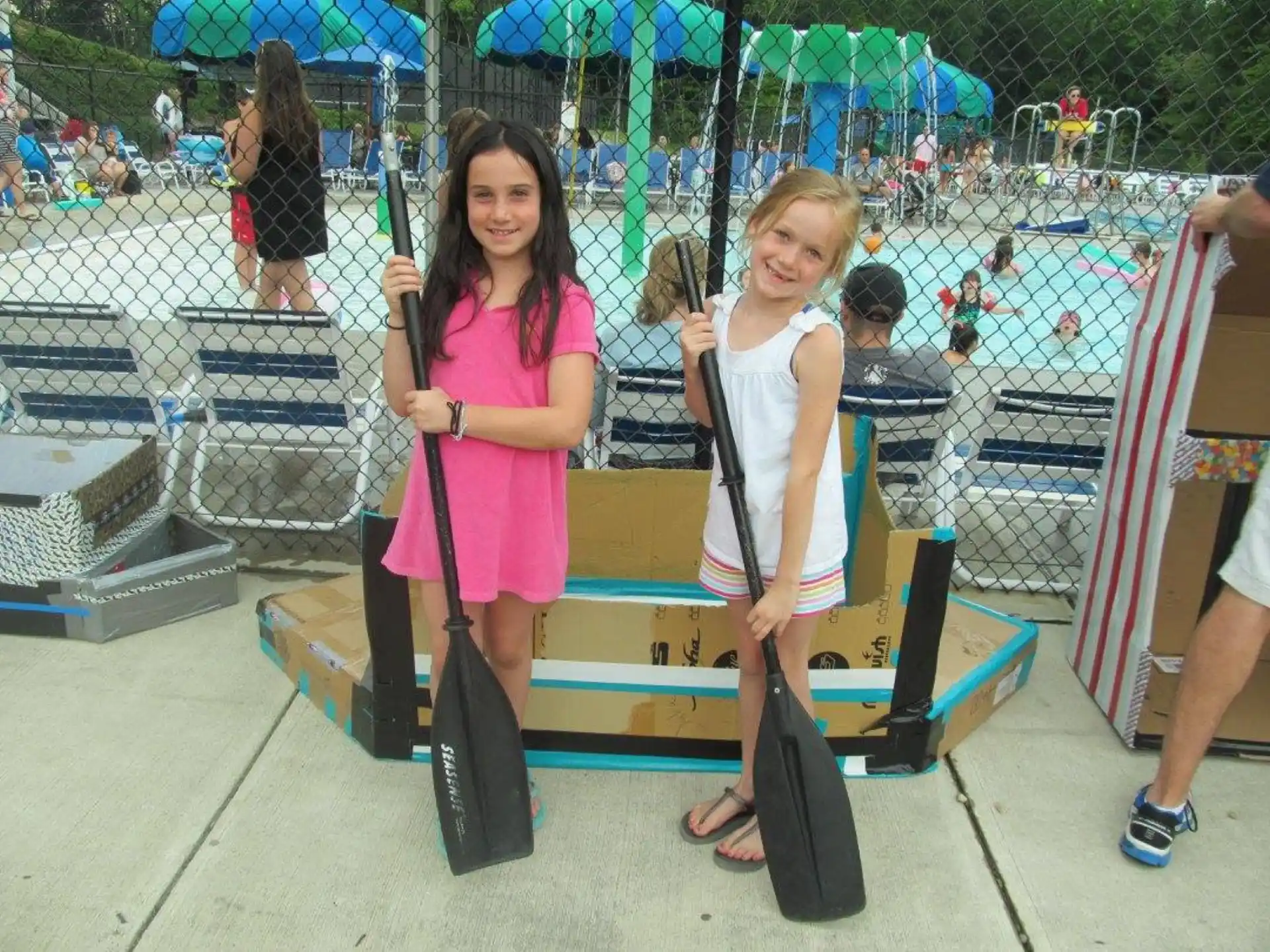 a couple of girls holding skateboards