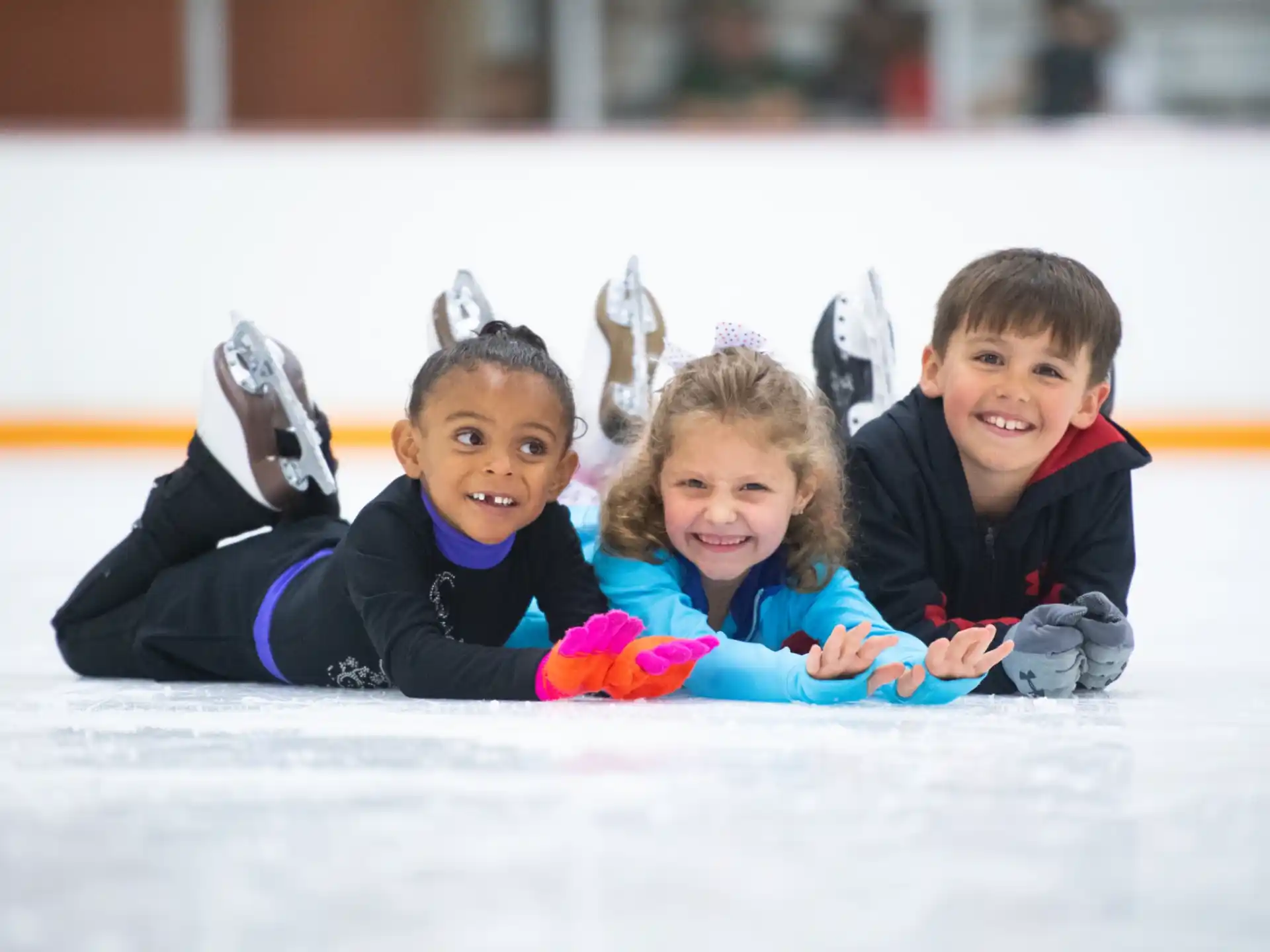 a group of children lying on the ground smiling for the camera
