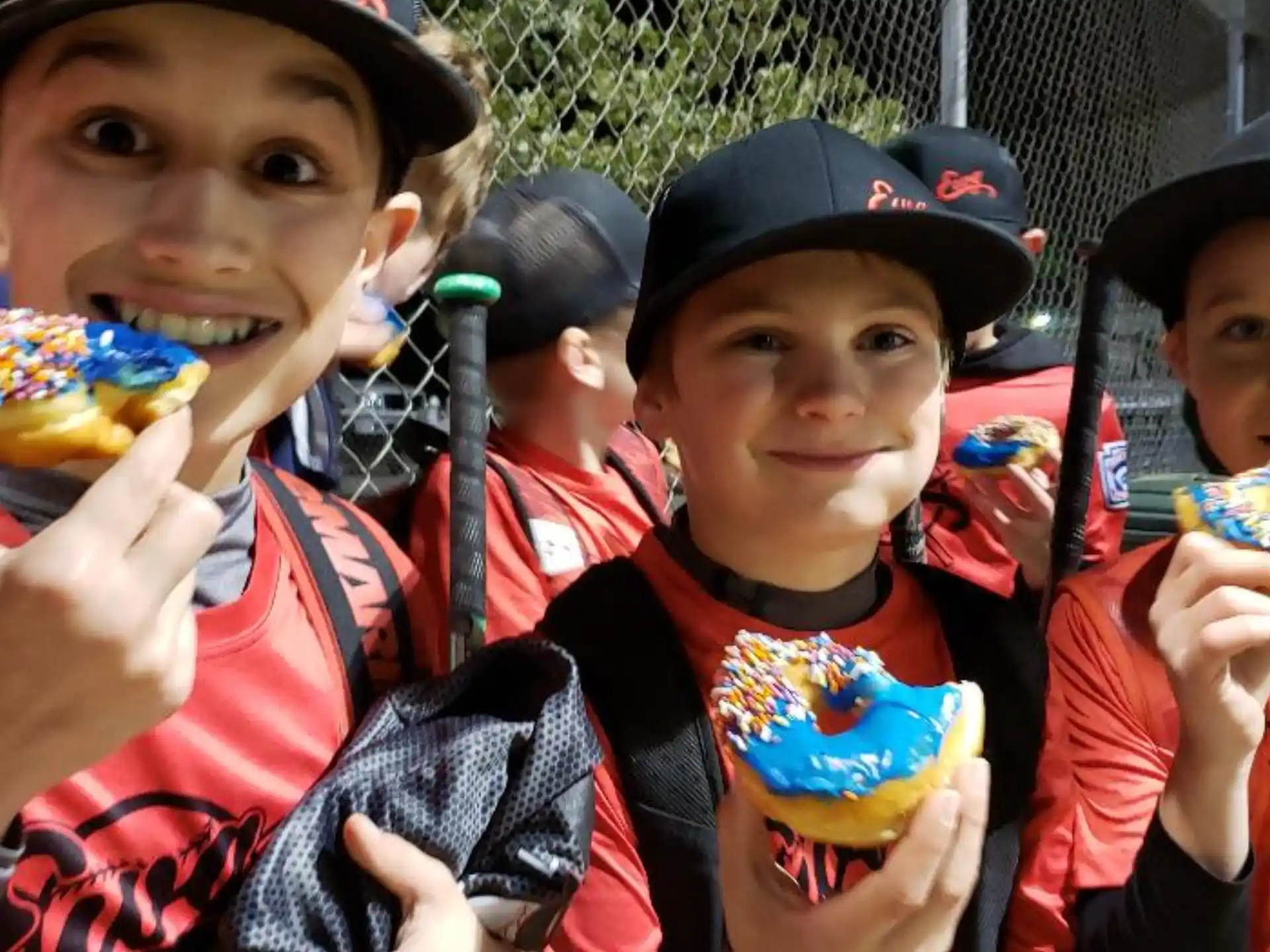 a group of kids eating donuts