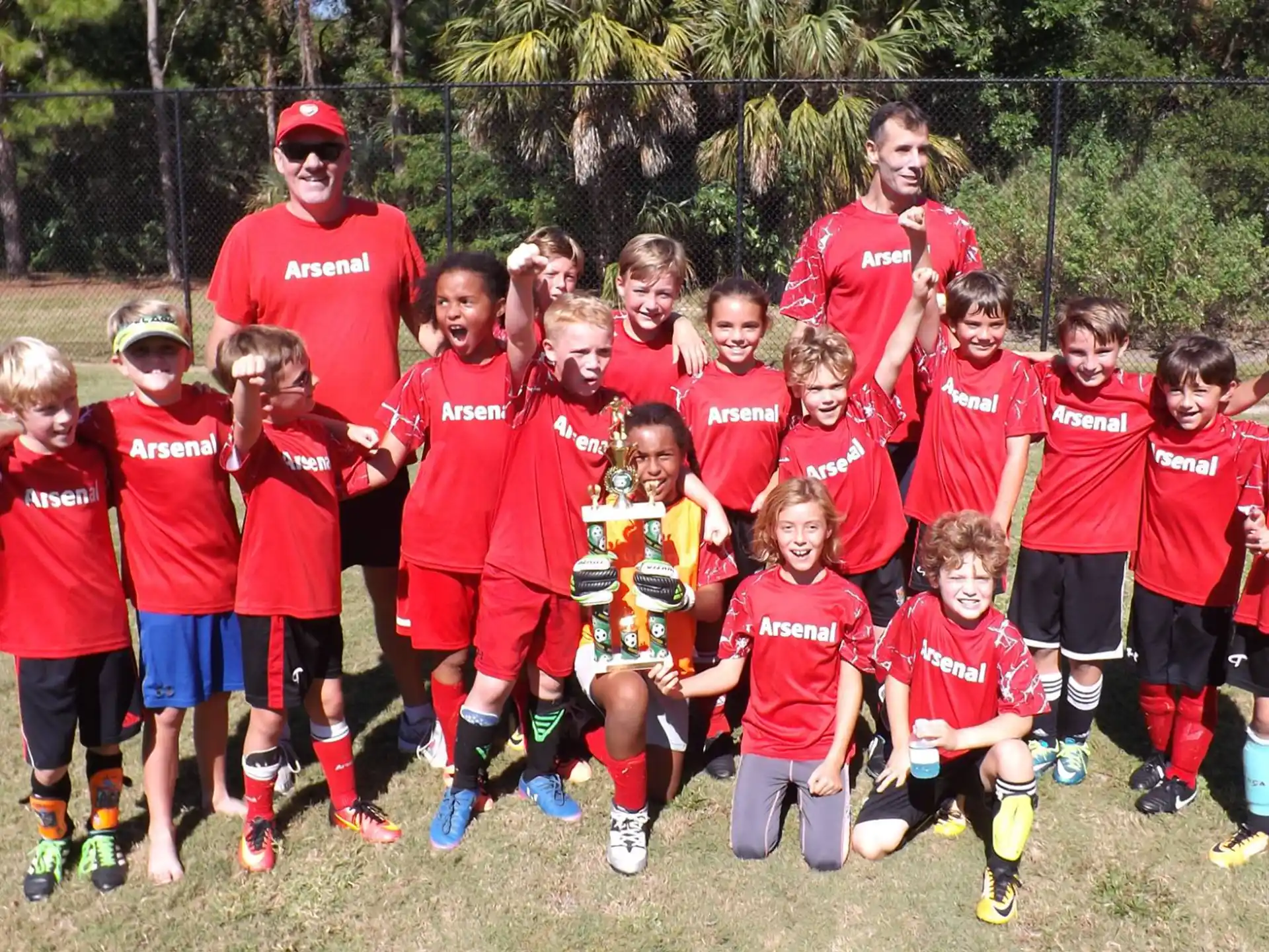 a group of children in red uniforms