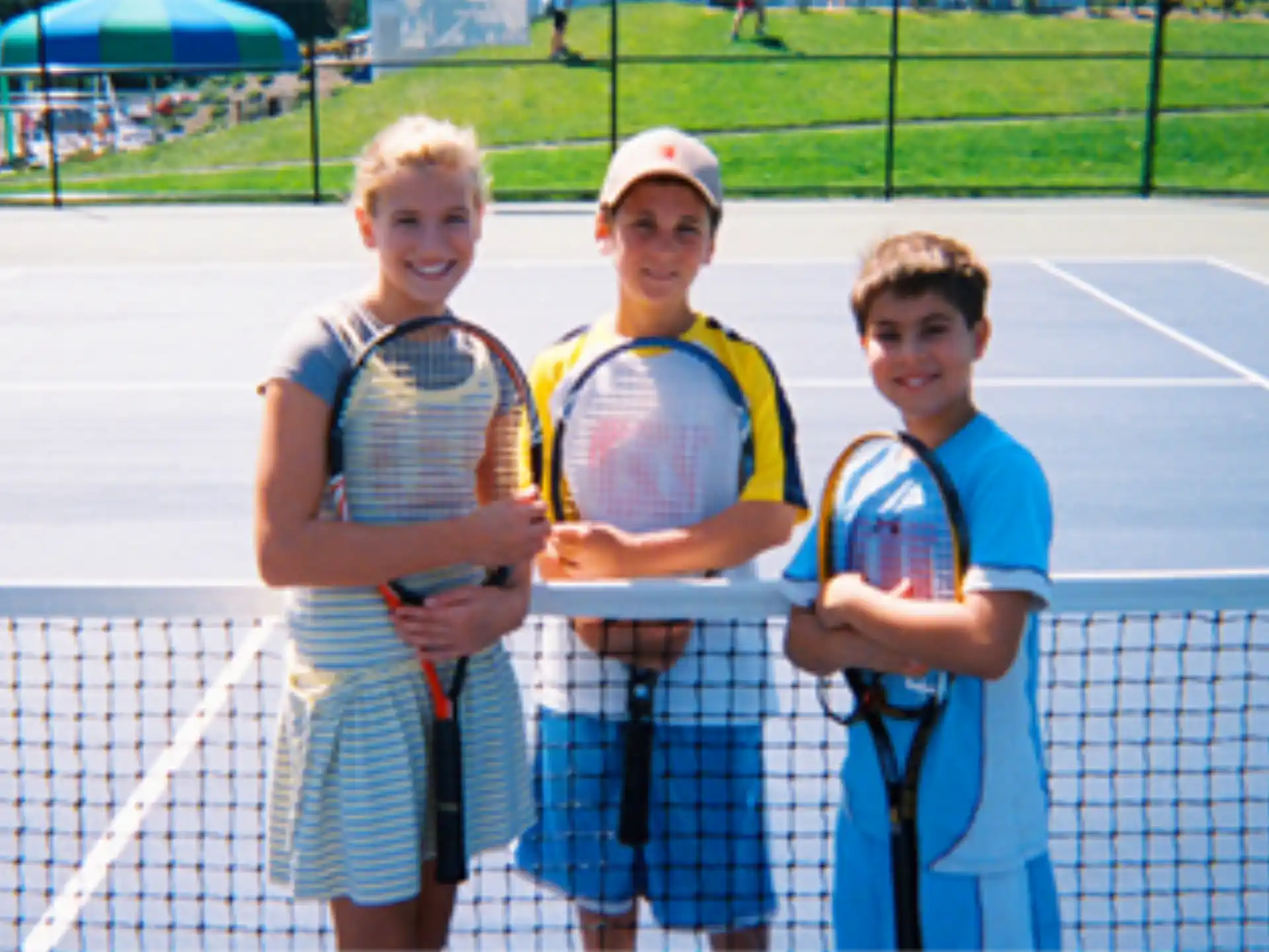 a group of boys holding tennis rackets