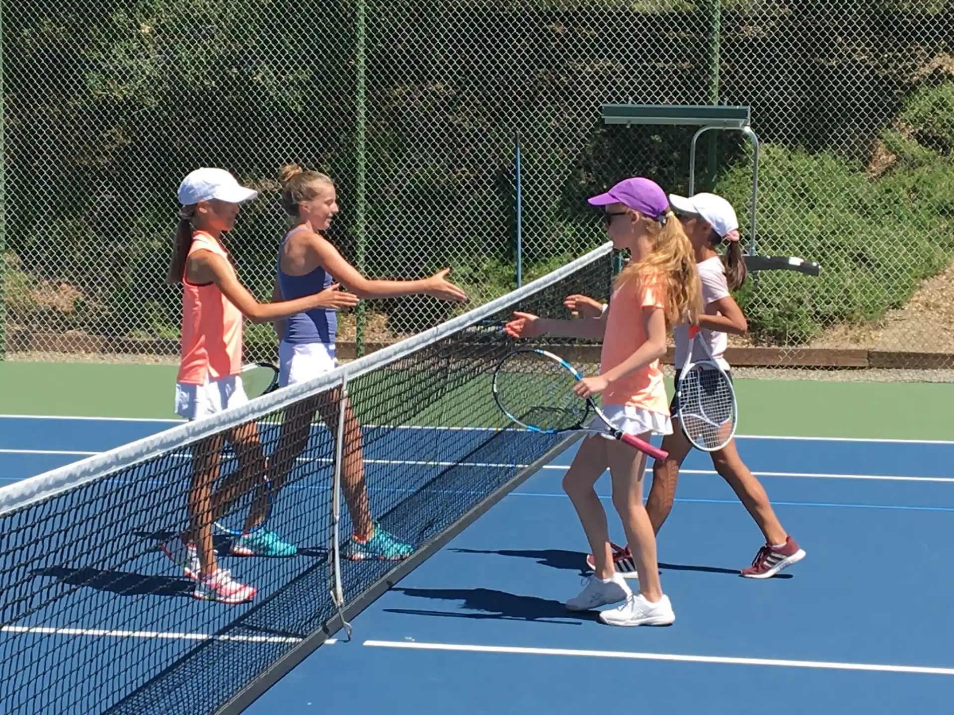 a group of girls playing tennis