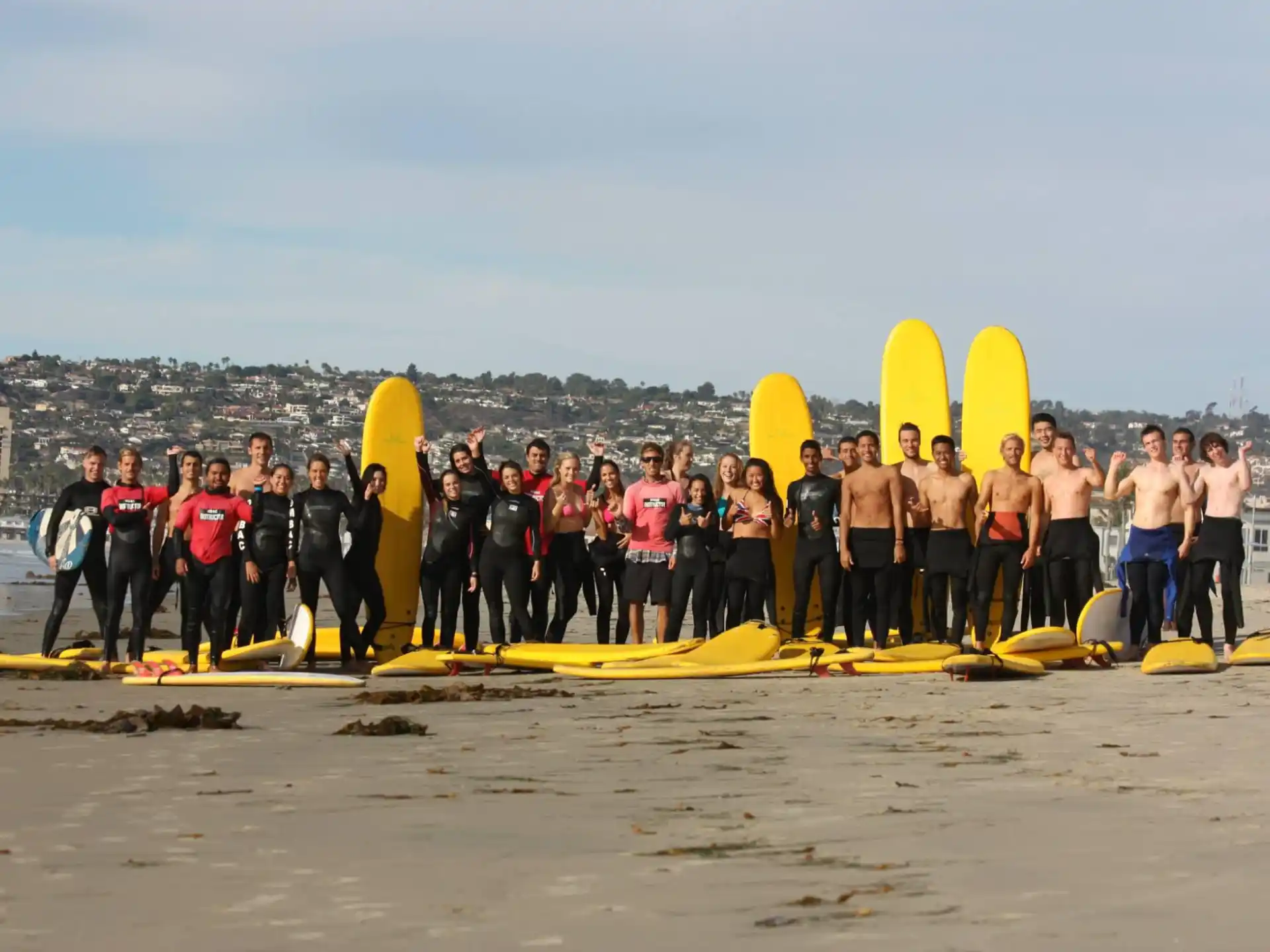 a group of surfers pose for a photo