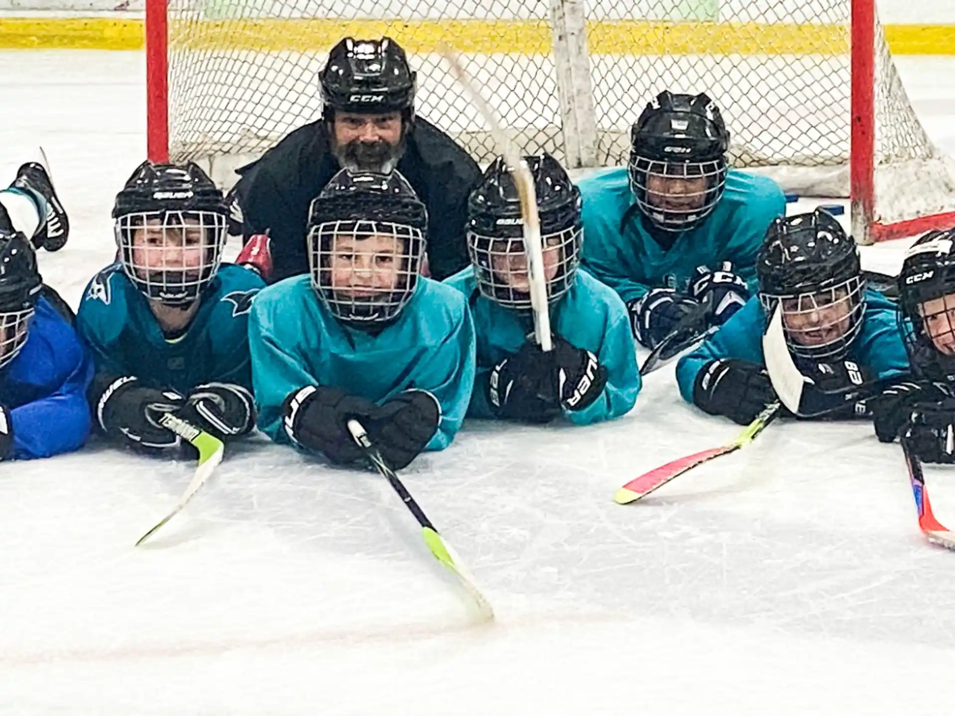 a group of people playing hockey