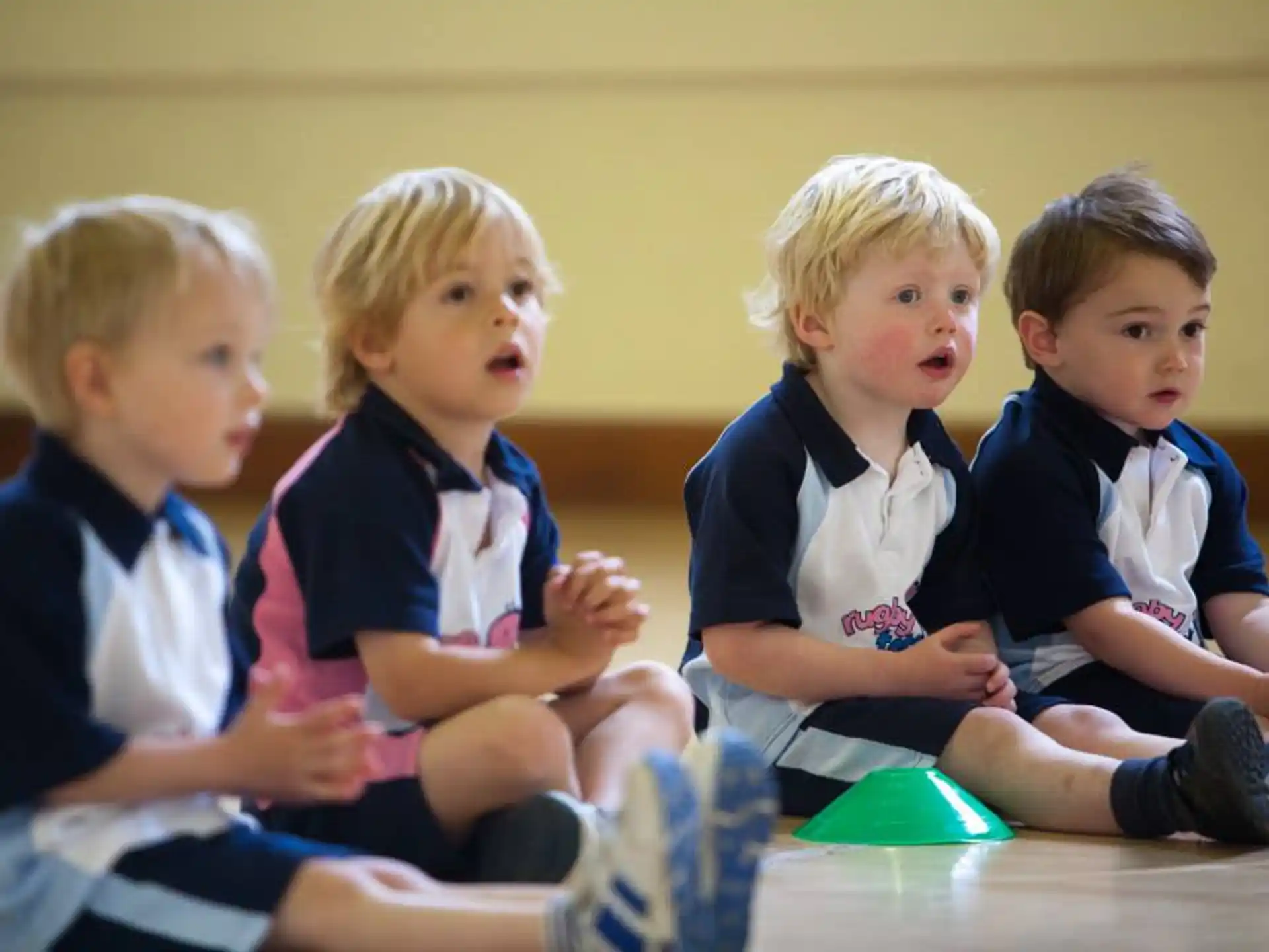 a group of boys sitting on the floor